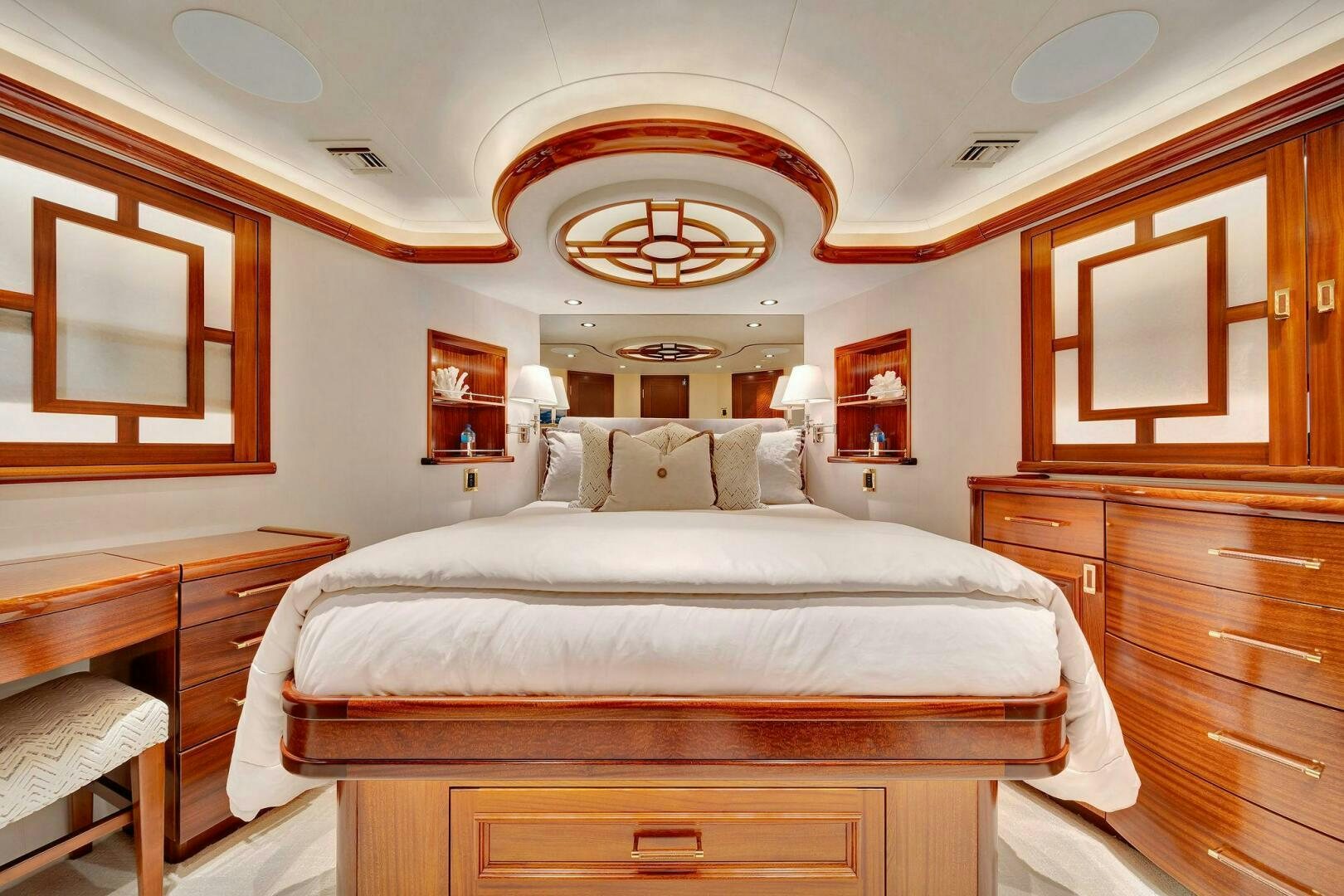 a bedroom with a bed and a dresser aboard JEANNIETINI NAME RESERVED Yacht for Sale