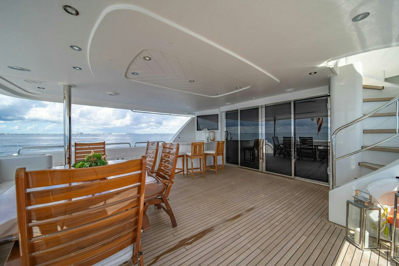 a room with a wood floor and a large window with a view of the ocean aboard JEANNIETINI NAME RESERVED Yacht for Sale
