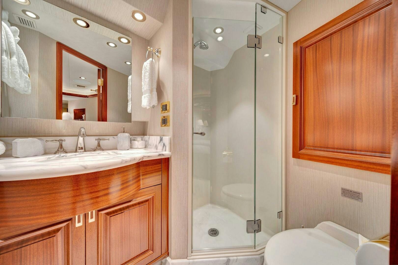a bathroom with a glass shower aboard JEANNIETINI NAME RESERVED Yacht for Sale