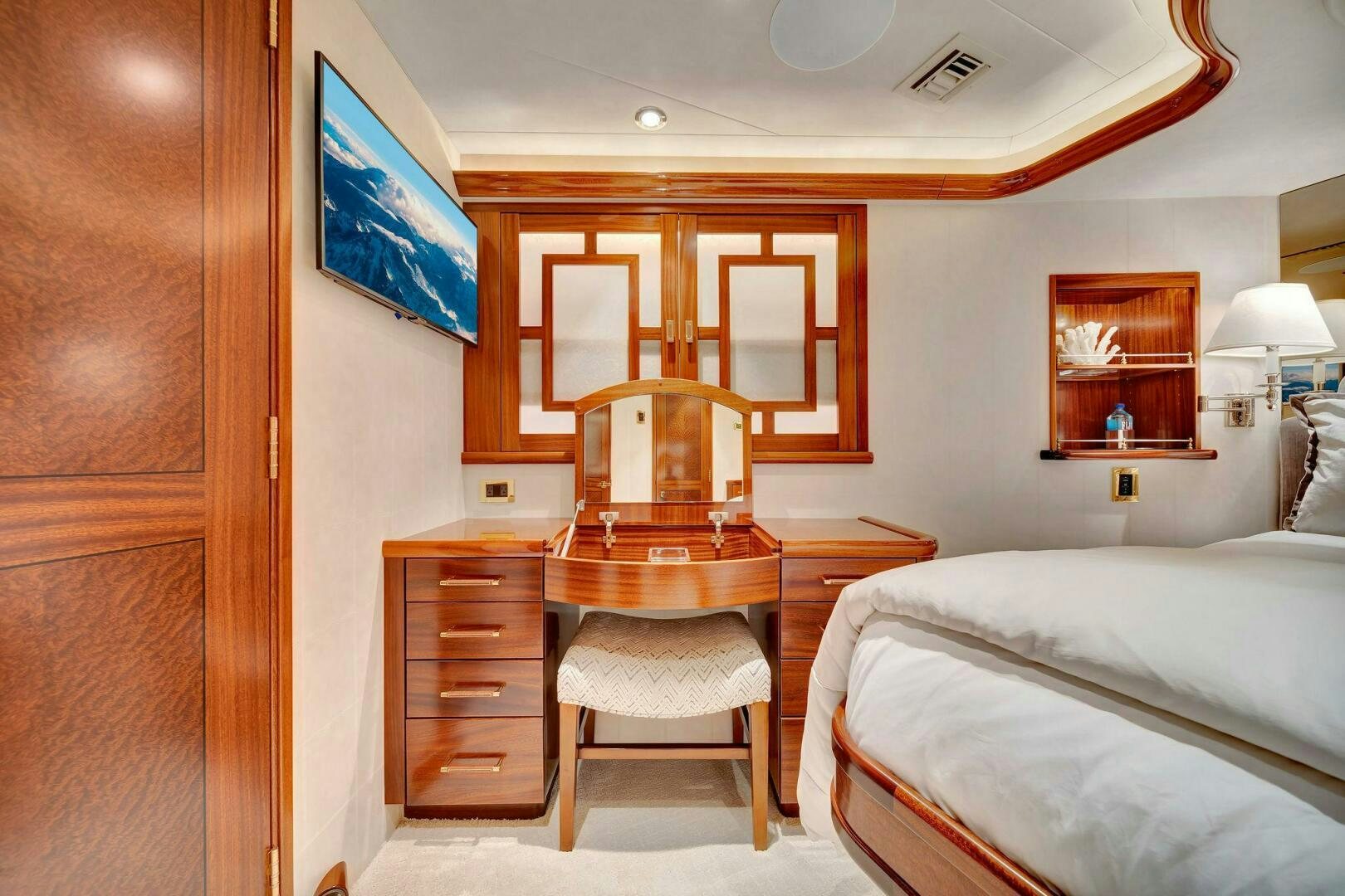a bedroom with a bed and a desk aboard JEANNIETINI NAME RESERVED Yacht for Sale