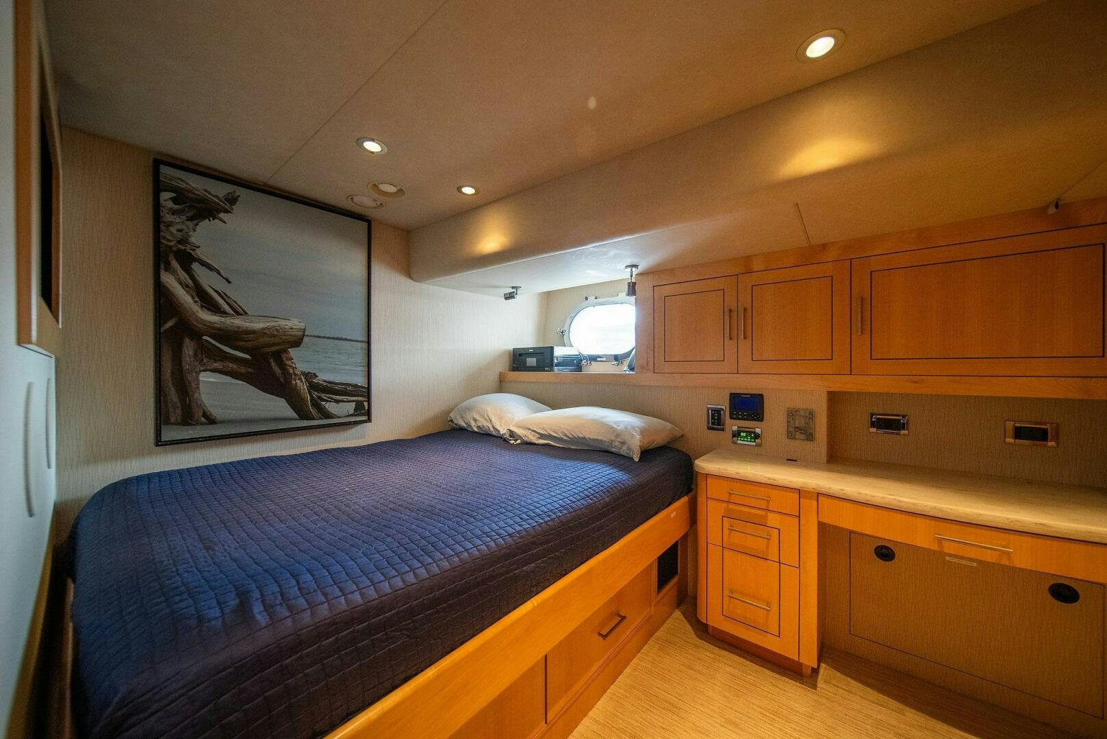 a bedroom with a bed and a painting on the wall aboard JEANNIETINI NAME RESERVED Yacht for Sale
