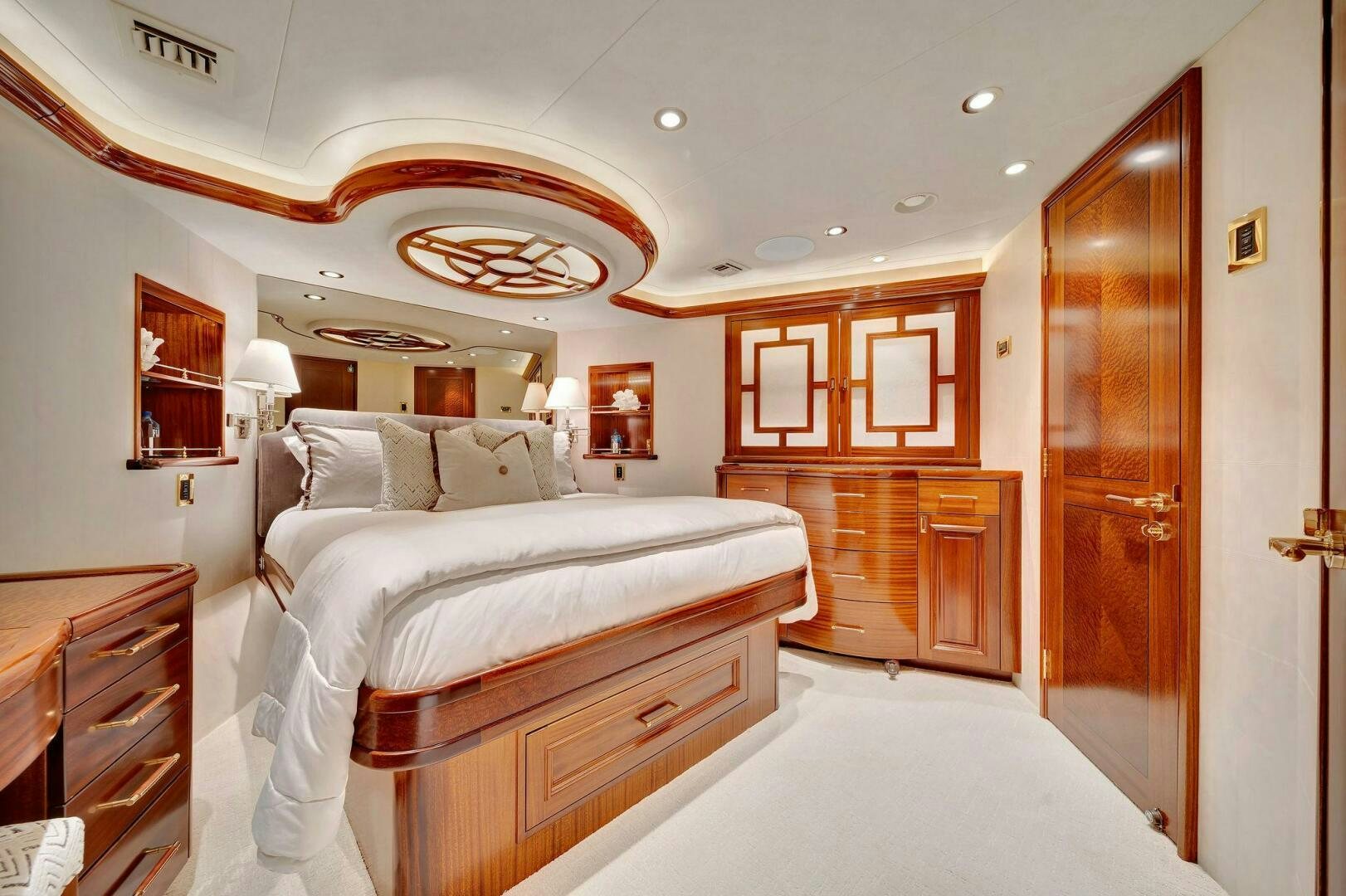 a bedroom with a bed and a closet aboard JEANNIETINI NAME RESERVED Yacht for Sale