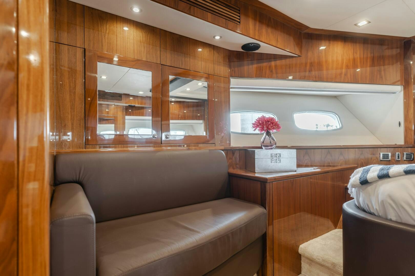 a room with a couch and a table aboard INDECENT PROPOSAL IV Yacht for Sale