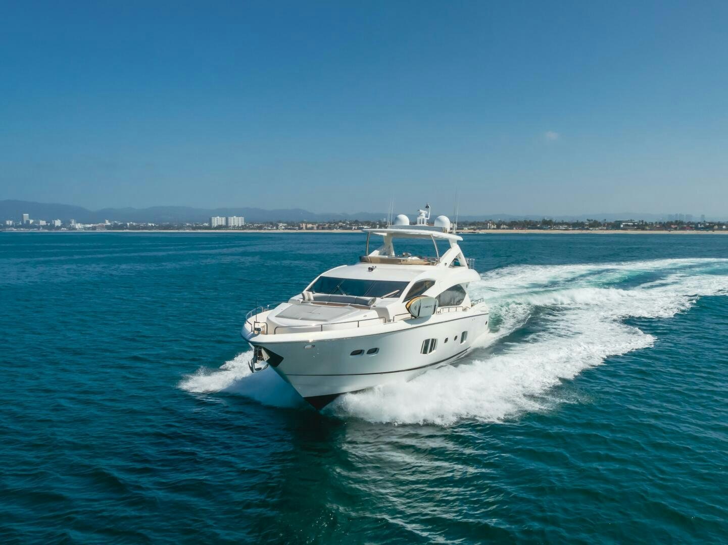 a white yacht on the water aboard INDECENT PROPOSAL IV Yacht for Sale
