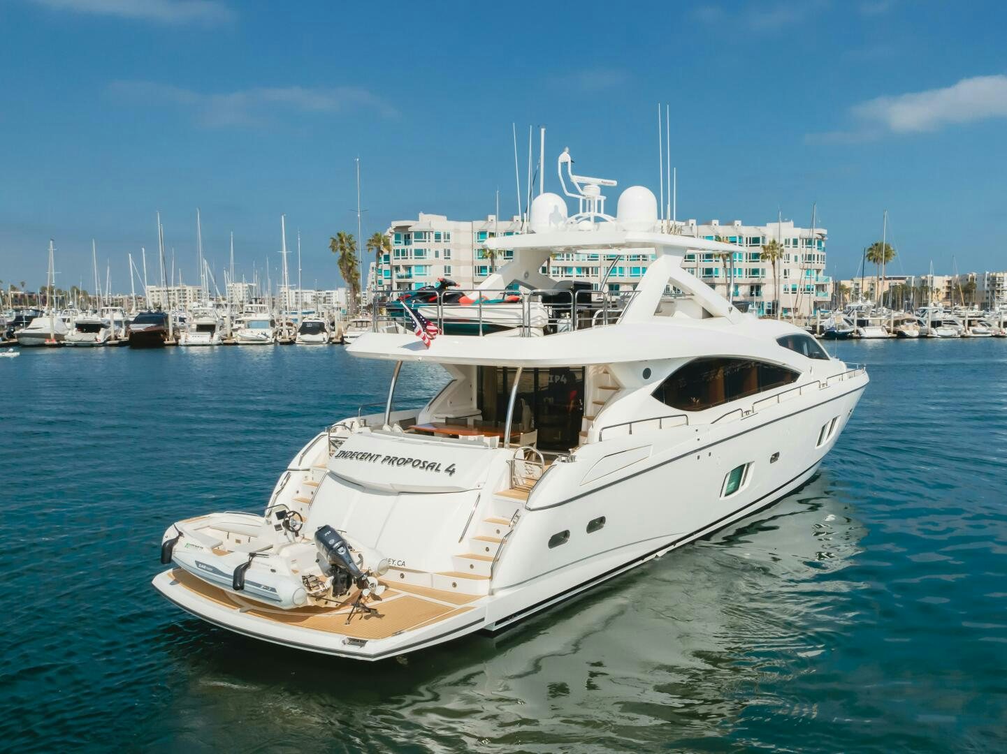 a white boat in the water aboard INDECENT PROPOSAL IV Yacht for Sale