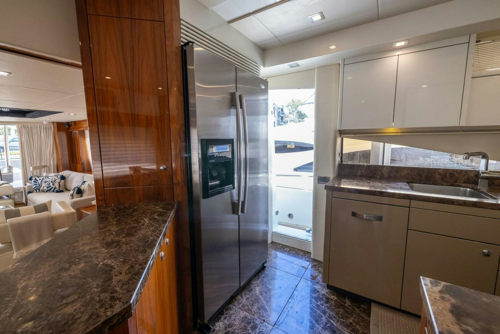 a kitchen with a large refrigerator aboard INDECENT PROPOSAL IV Yacht for Sale