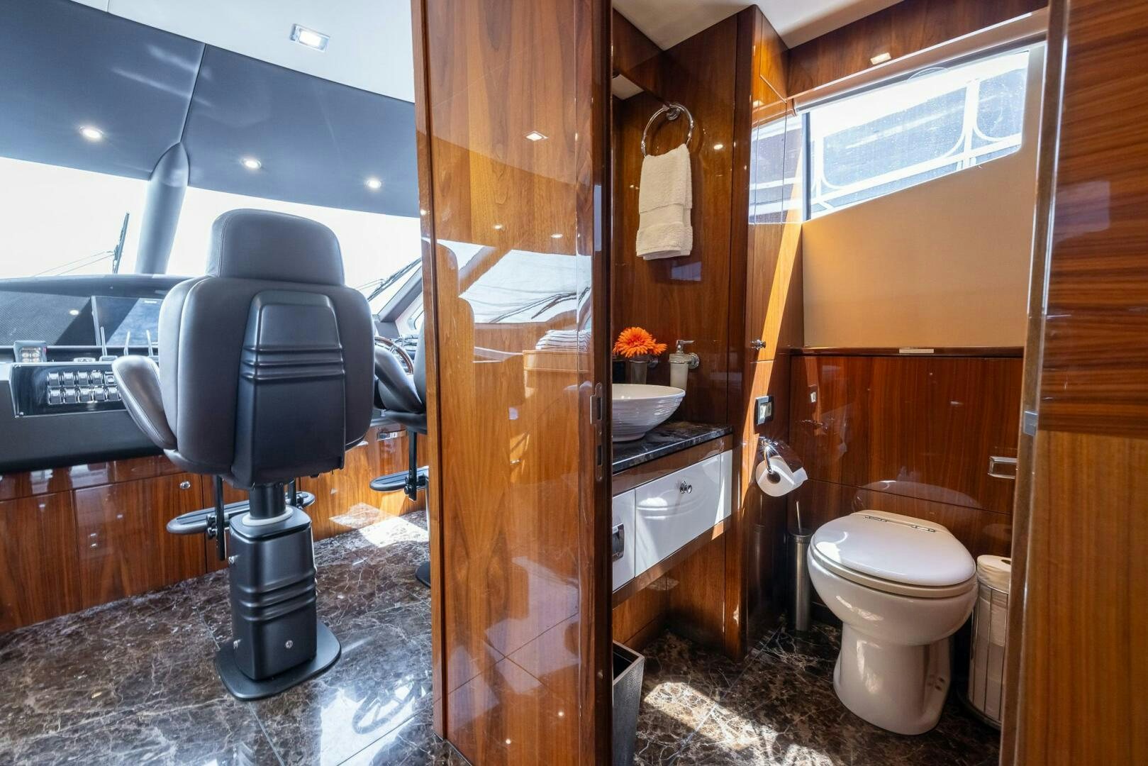a bathroom with a toilet and sink aboard INDECENT PROPOSAL IV Yacht for Sale