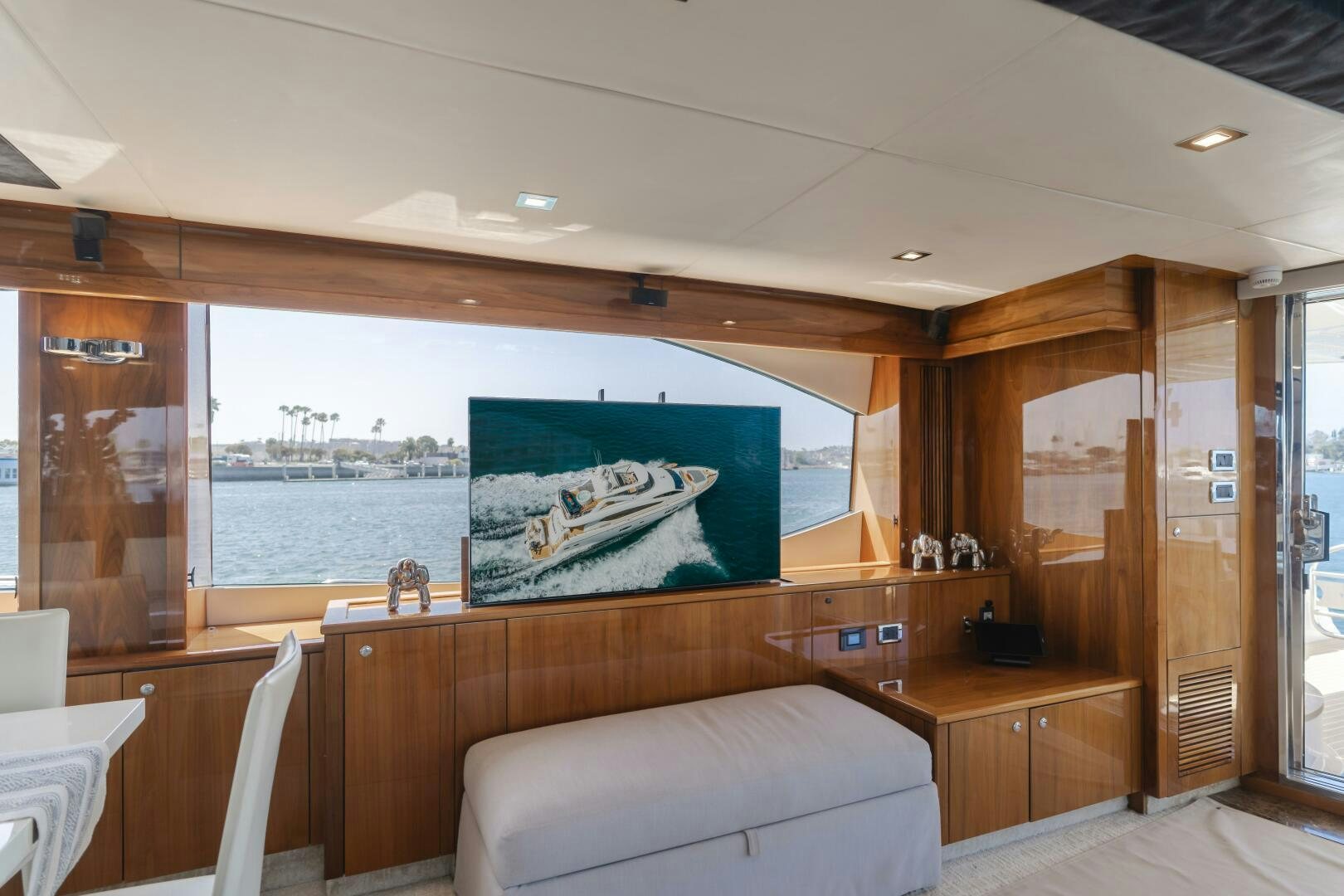 a room with a large window and a couch aboard INDECENT PROPOSAL IV Yacht for Sale