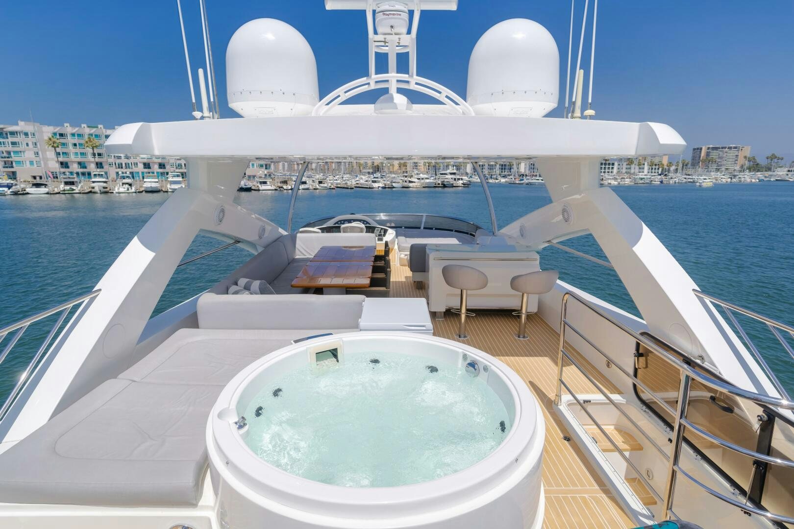 a large white boat with a white roof and a table and chairs on a boat aboard INDECENT PROPOSAL IV Yacht for Sale