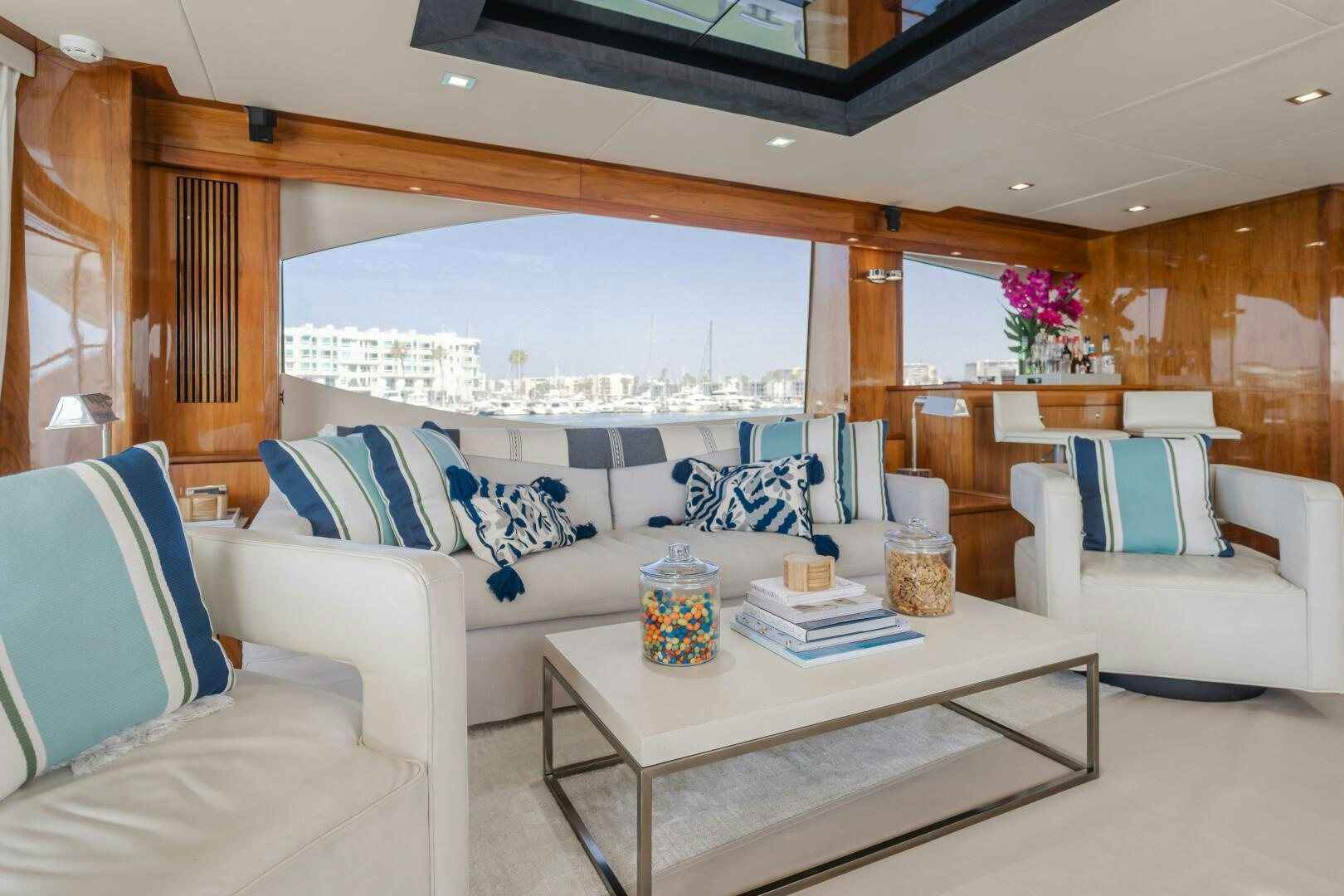 a living room with a large window aboard INDECENT PROPOSAL IV Yacht for Sale