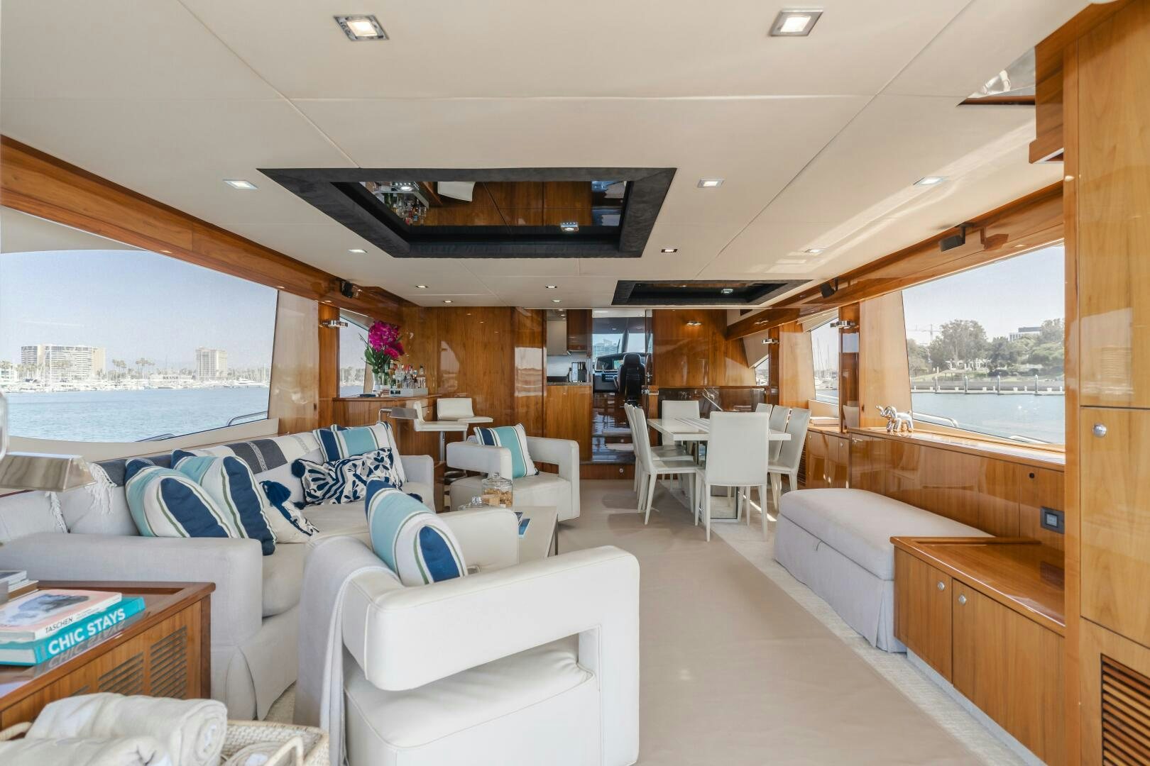 a living room with a view of the water aboard INDECENT PROPOSAL IV Yacht for Sale