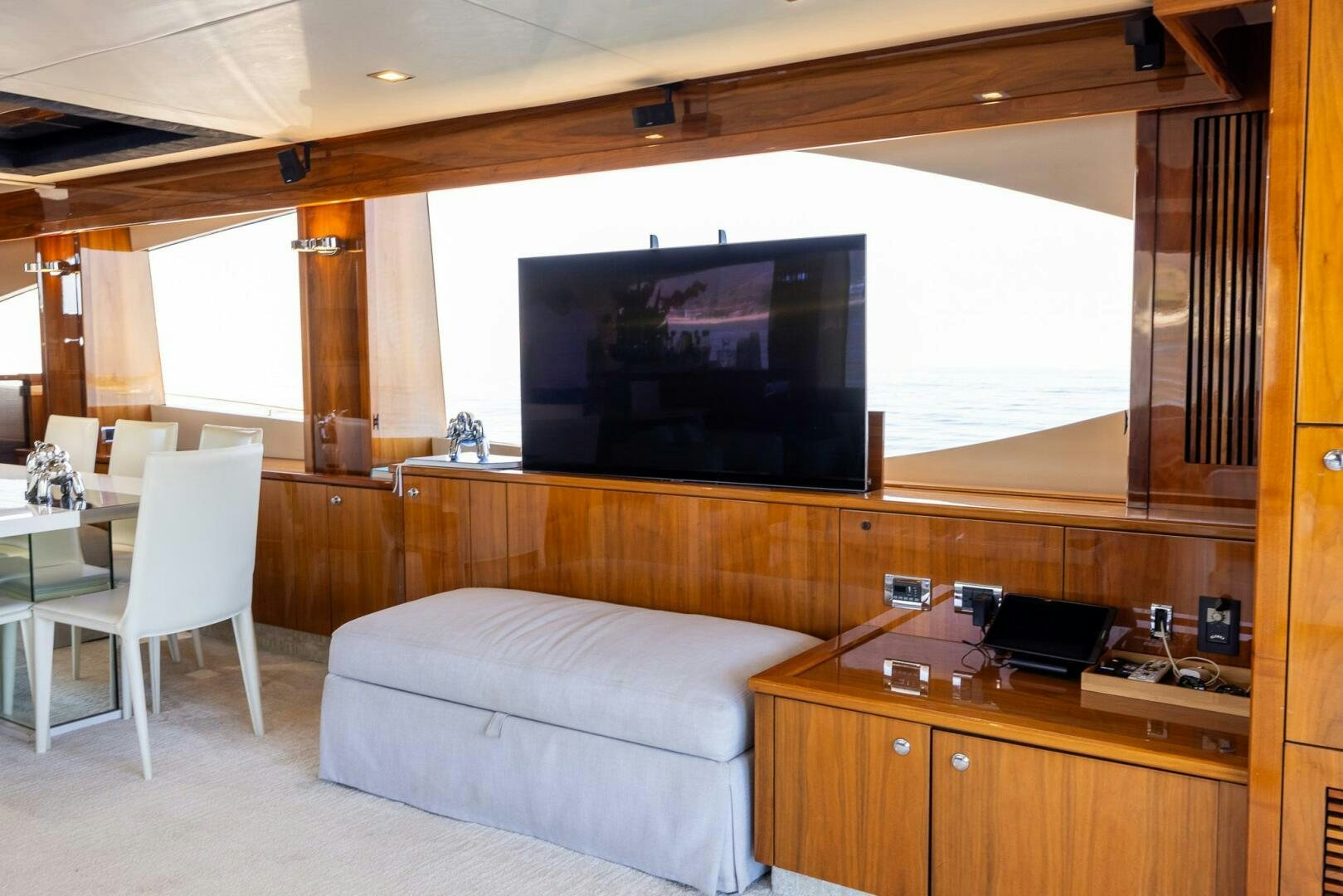 a living room with a large television aboard INDECENT PROPOSAL IV Yacht for Sale