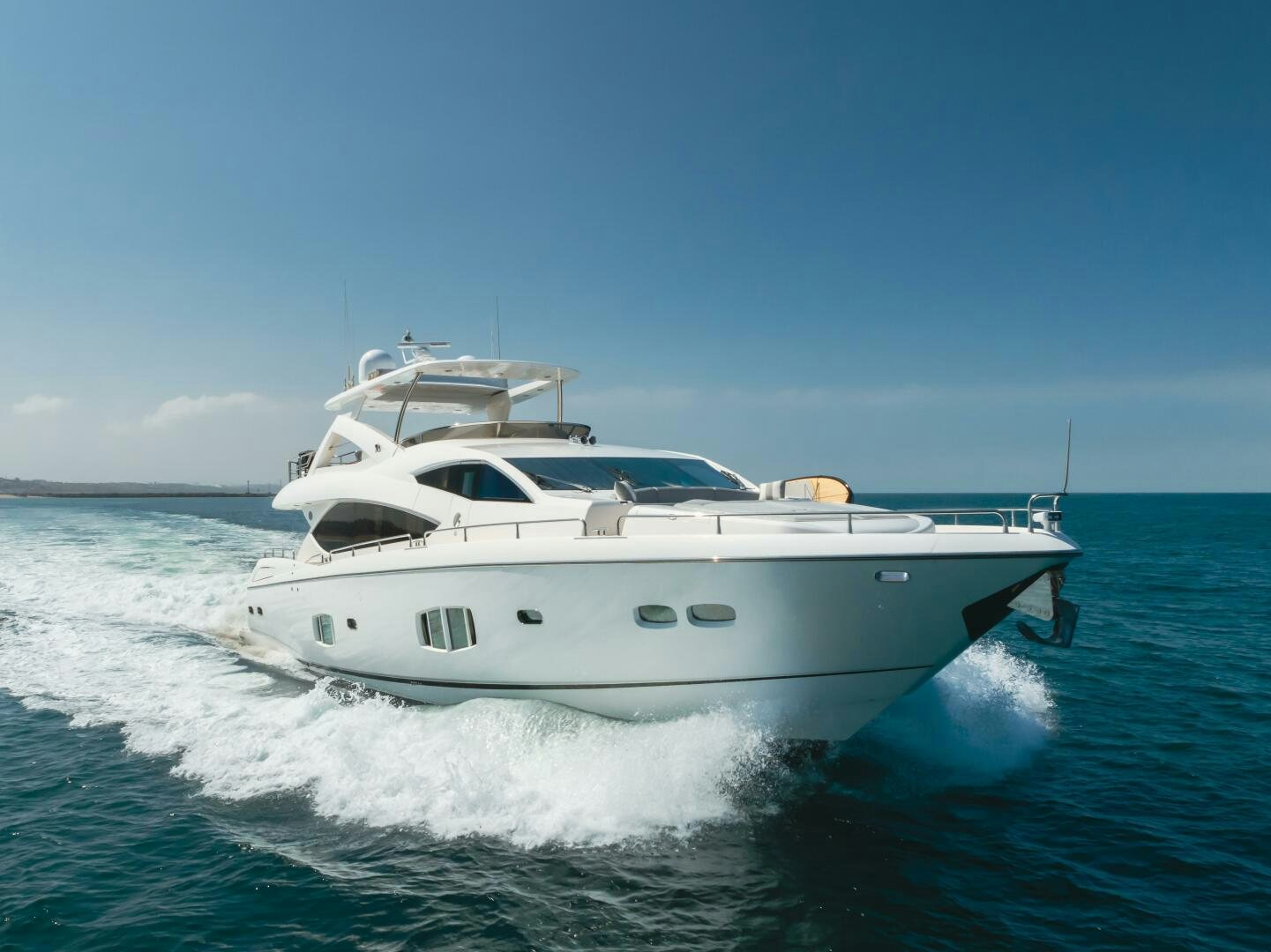 a white yacht on the water aboard INDECENT PROPOSAL IV Yacht for Sale