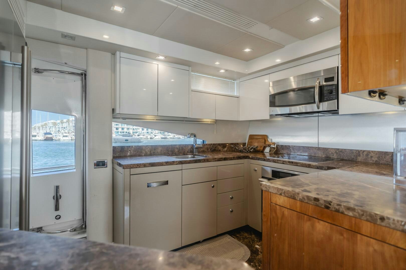 a kitchen with white cabinets aboard INDECENT PROPOSAL IV Yacht for Sale