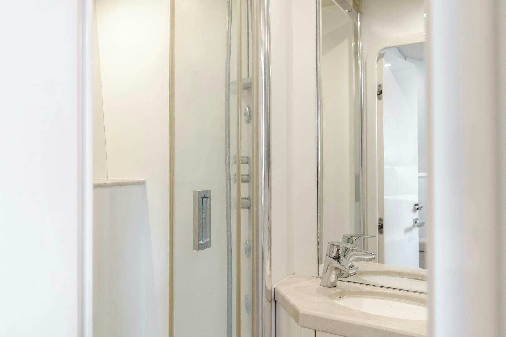 a bathroom with a sink and a mirror aboard INDECENT PROPOSAL IV Yacht for Sale