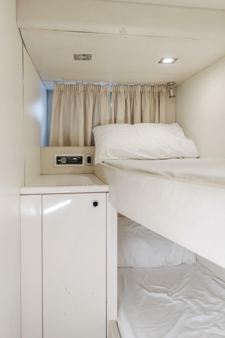 a room with a bed and a window aboard INDECENT PROPOSAL IV Yacht for Sale