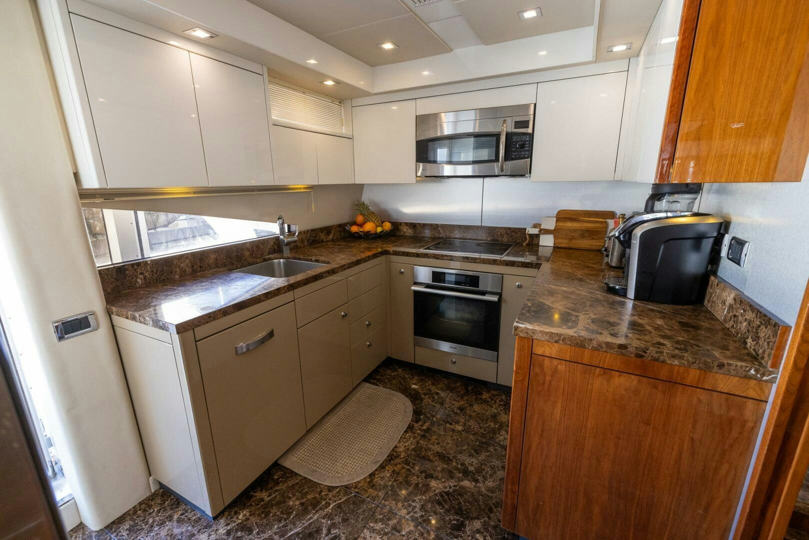 a kitchen with a stove and oven aboard INDECENT PROPOSAL IV Yacht for Sale