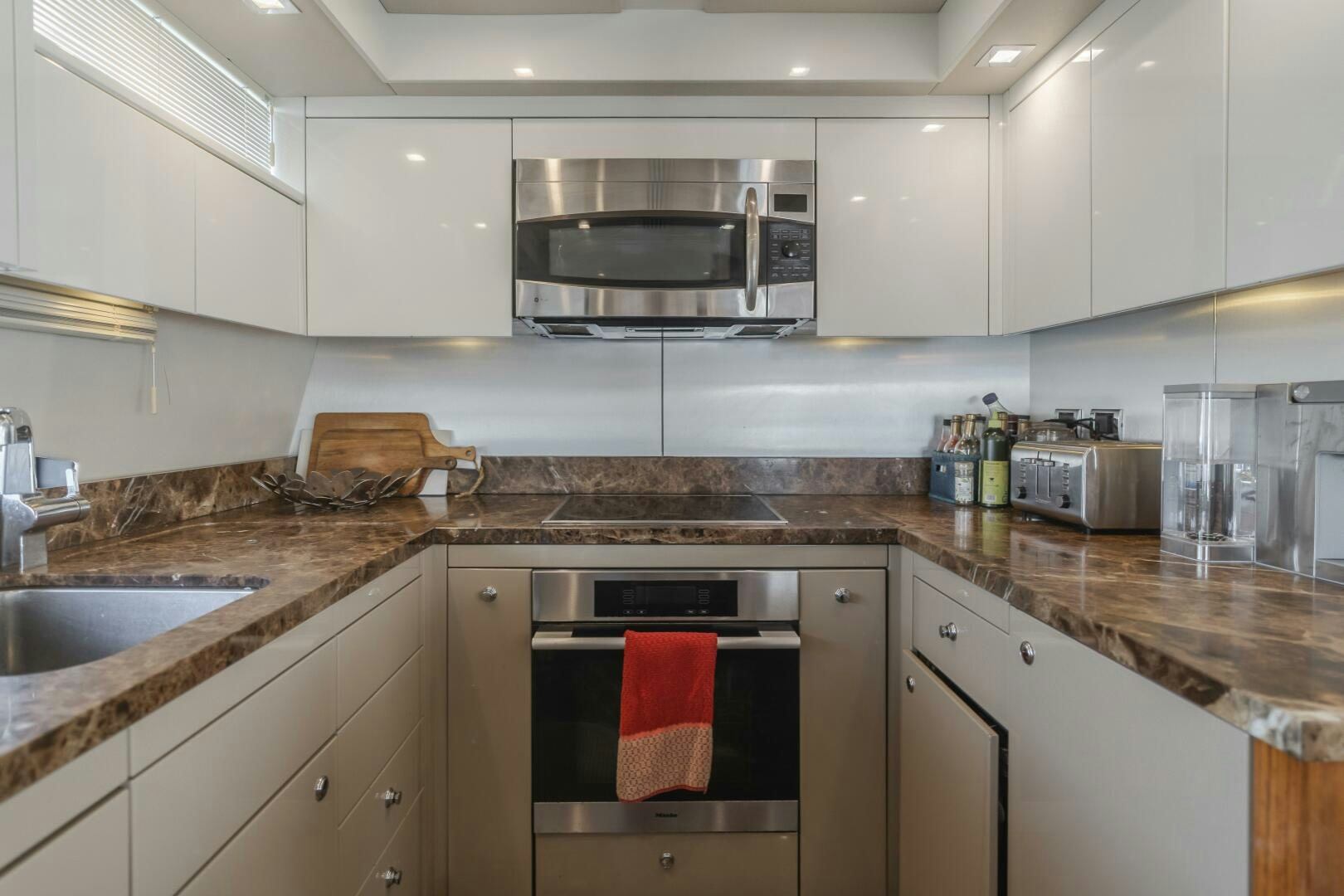 a kitchen with a microwave oven and a sink aboard INDECENT PROPOSAL IV Yacht for Sale