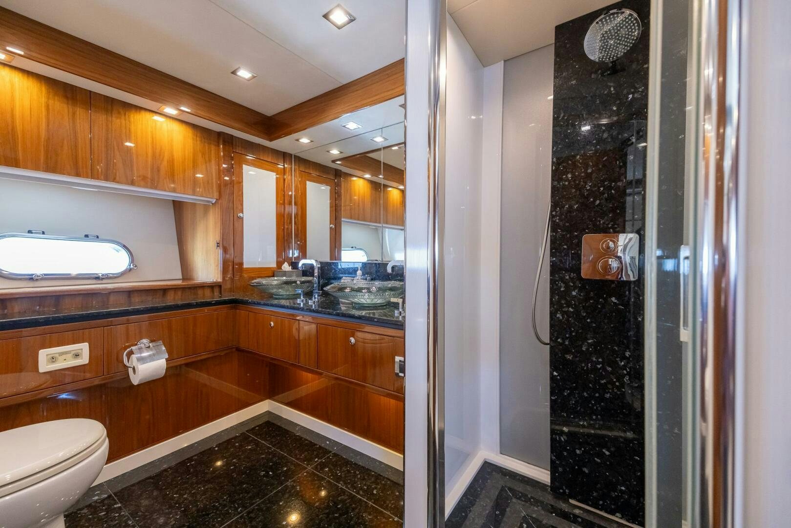 a bathroom with a large mirror aboard INDECENT PROPOSAL IV Yacht for Sale
