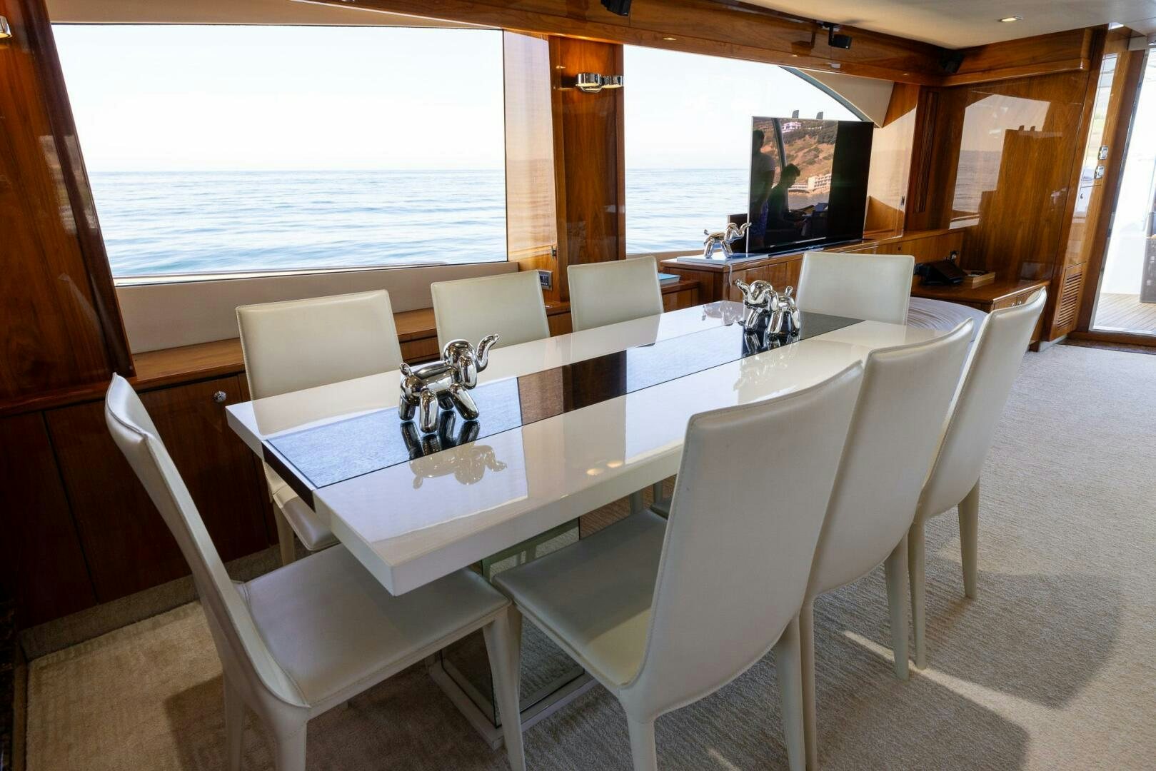 a white dining table with chairs aboard INDECENT PROPOSAL IV Yacht for Sale