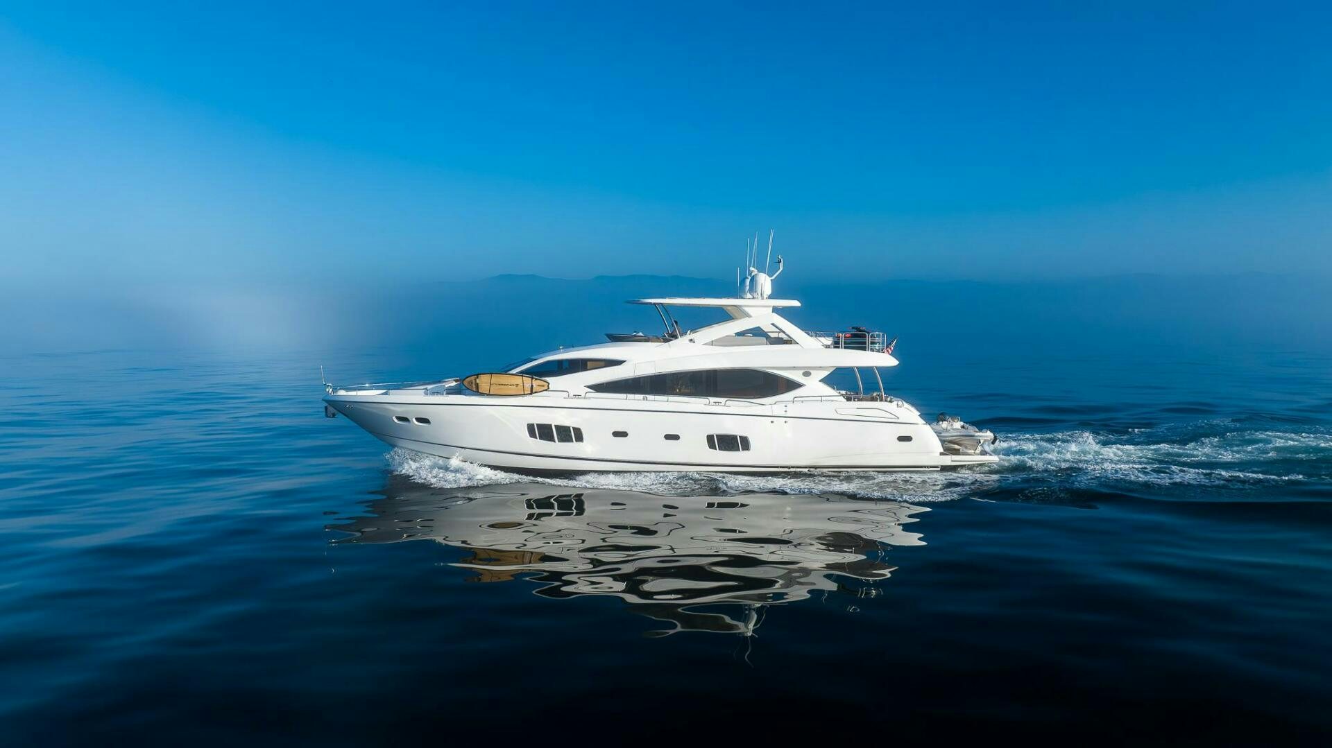 a white yacht on the water aboard INDECENT PROPOSAL IV Yacht for Sale