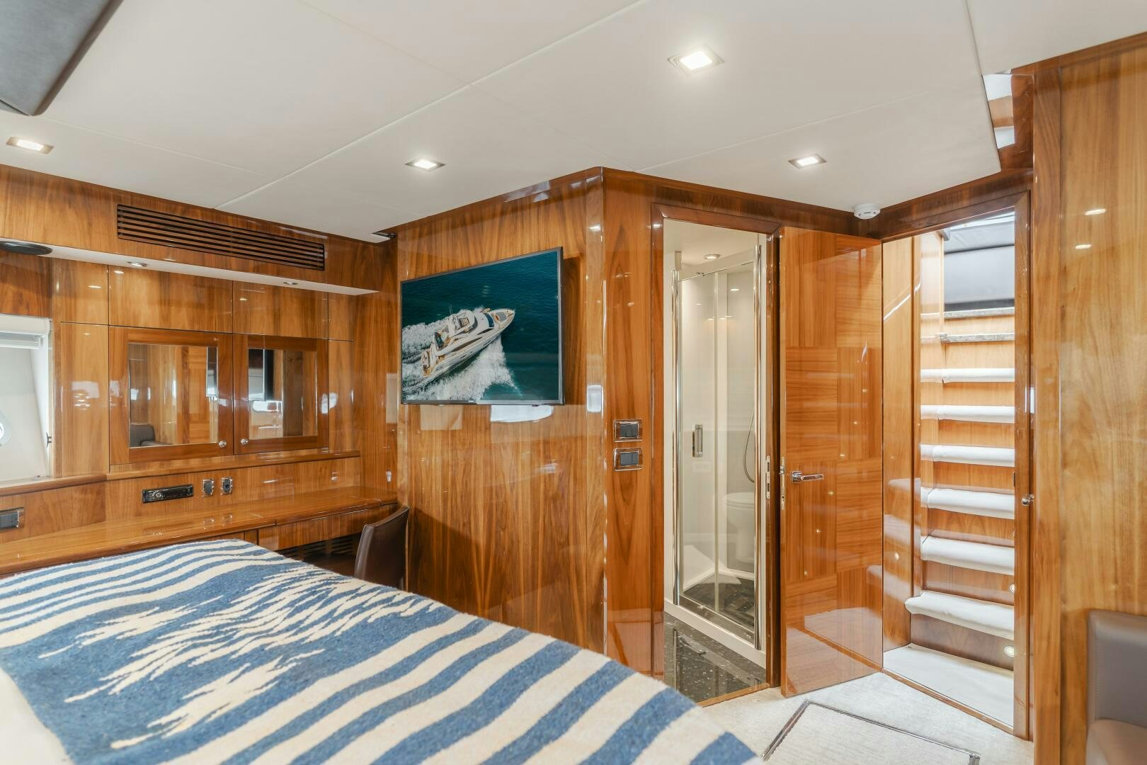 a bedroom with a wood closet aboard INDECENT PROPOSAL IV Yacht for Sale
