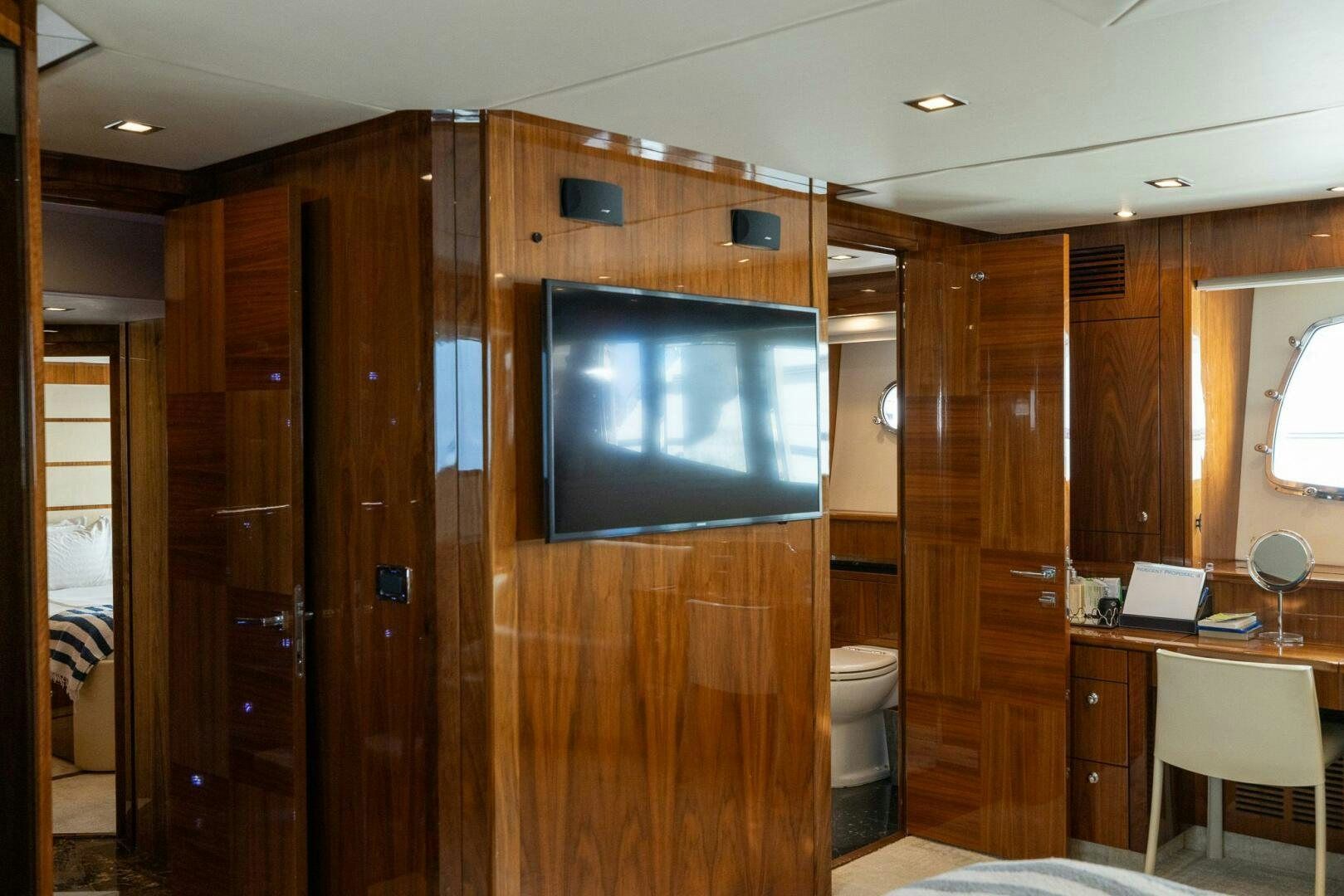 a bathroom with a wood closet aboard INDECENT PROPOSAL IV Yacht for Sale