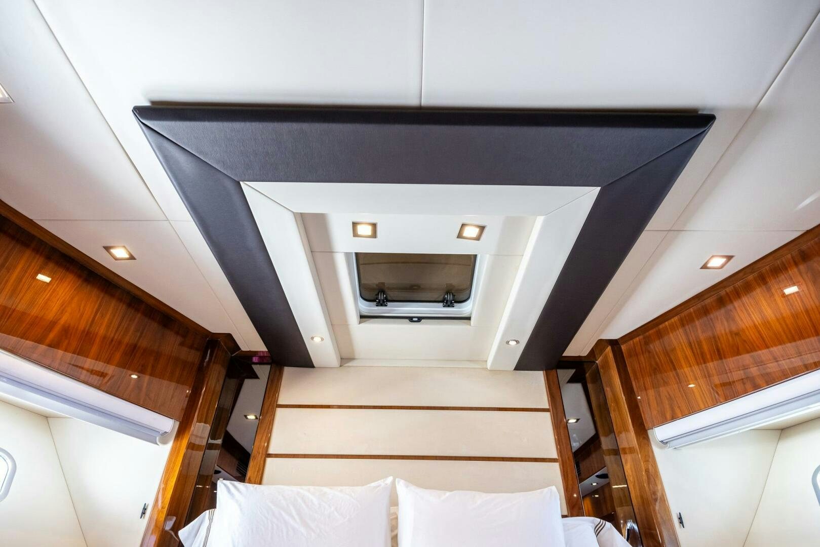 a room with a bed and a television on the ceiling aboard INDECENT PROPOSAL IV Yacht for Sale
