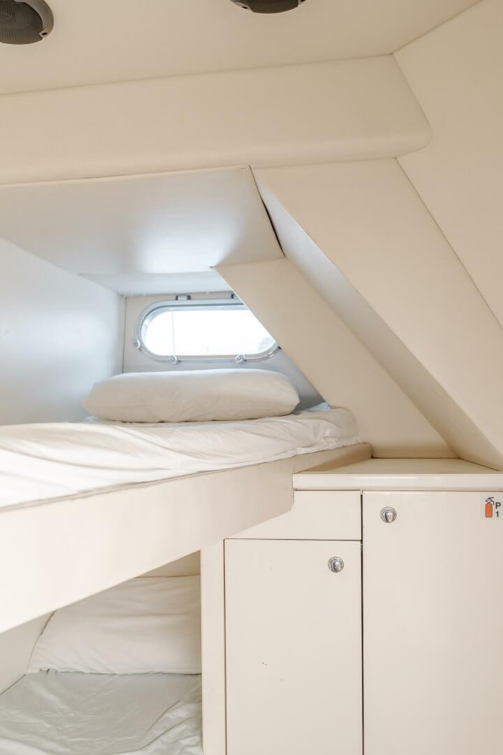 a room with a bed and a window aboard INDECENT PROPOSAL IV Yacht for Sale