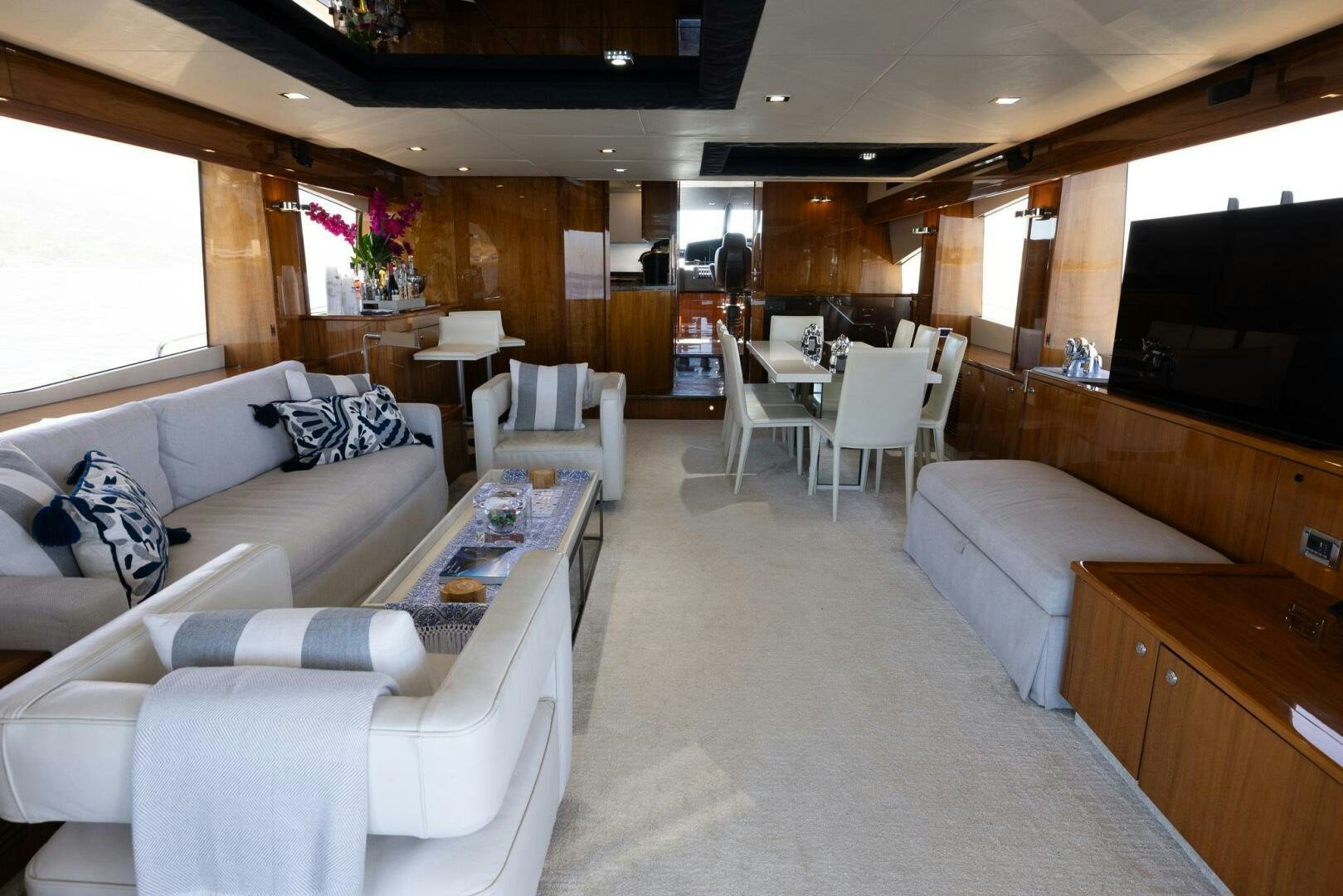 a living room with a couch and a table aboard INDECENT PROPOSAL IV Yacht for Sale