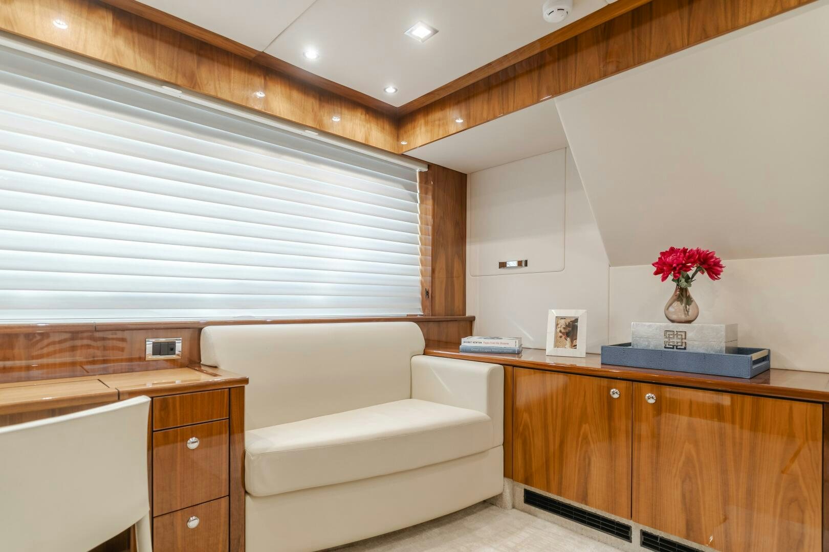 a room with a couch and a table aboard INDECENT PROPOSAL IV Yacht for Sale
