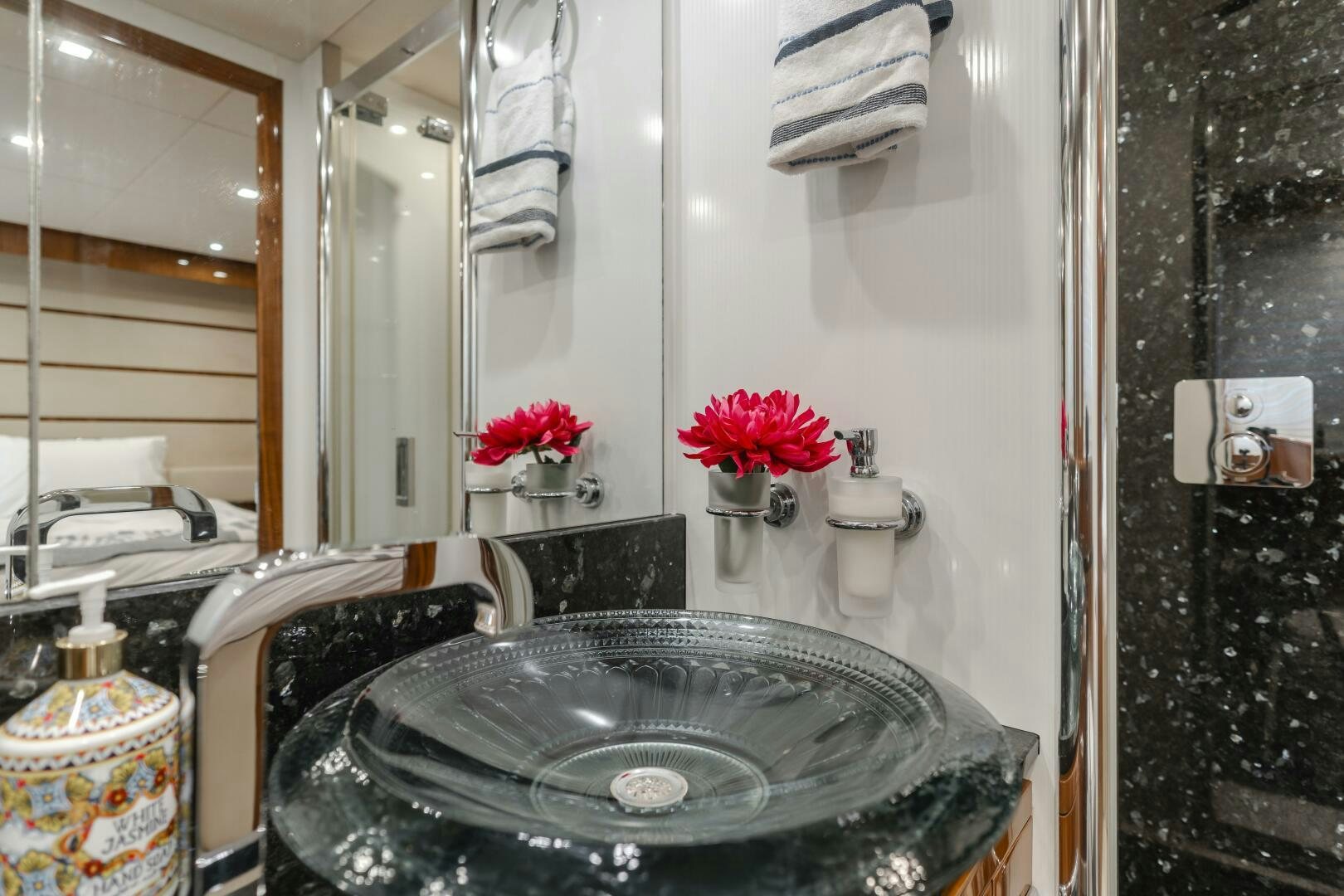 a bathroom with a sink and toilet aboard INDECENT PROPOSAL IV Yacht for Sale