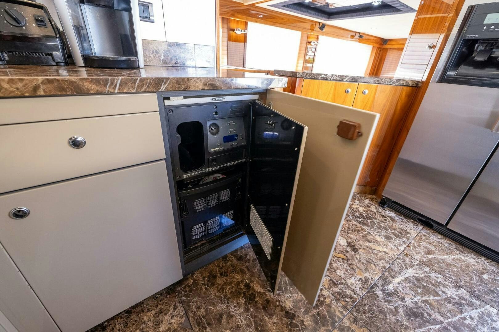 a kitchen with a stove and cabinets aboard INDECENT PROPOSAL IV Yacht for Sale