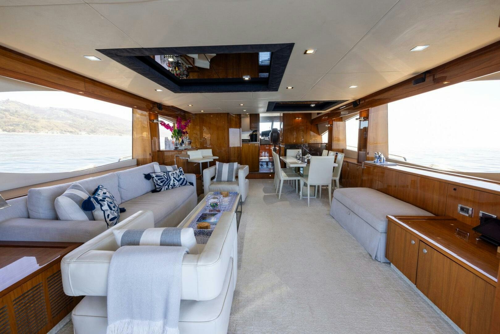 a living room with a couch and a table aboard INDECENT PROPOSAL IV Yacht for Sale