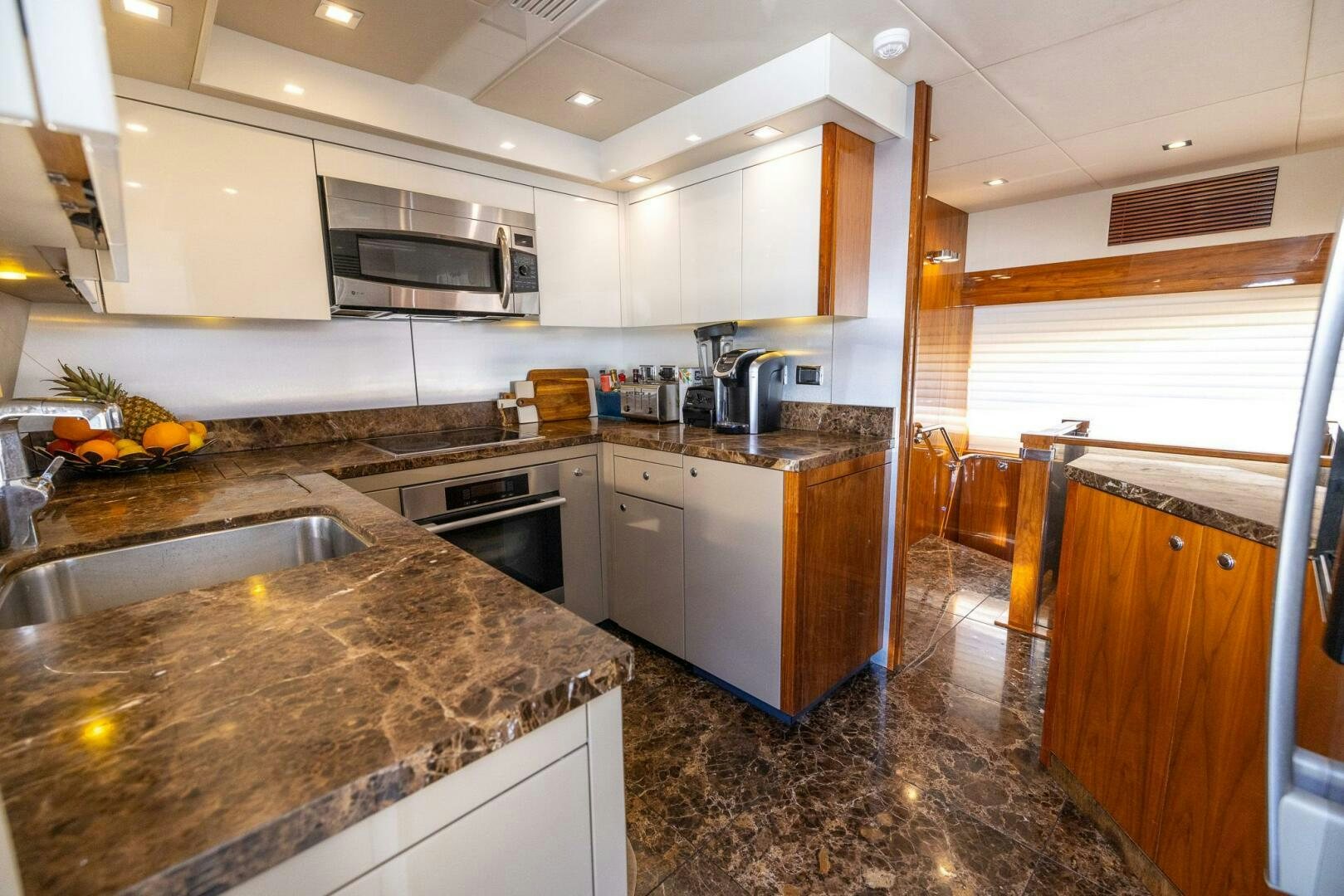 a kitchen with a marble counter top aboard INDECENT PROPOSAL IV Yacht for Sale