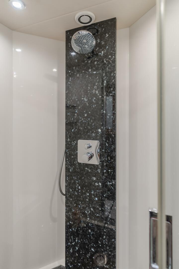 a shower with a shower head aboard INDECENT PROPOSAL IV Yacht for Sale
