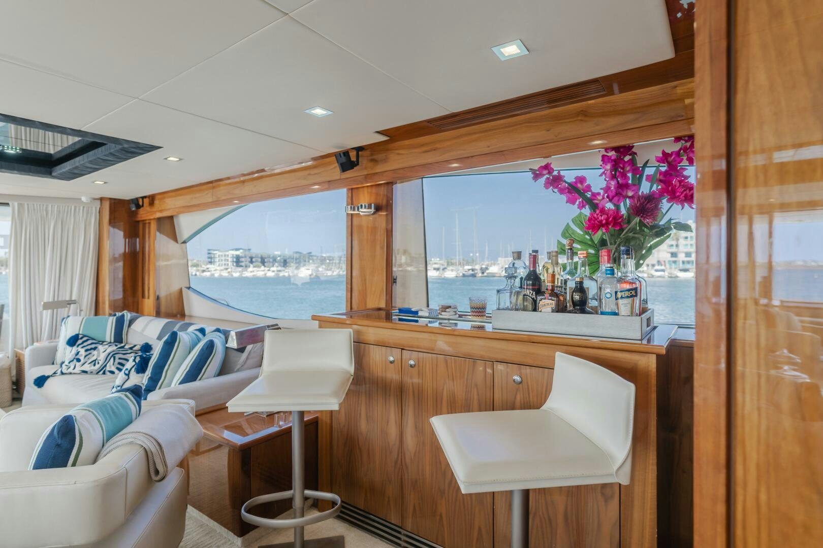 a room with a desk and a window with a view of the water aboard INDECENT PROPOSAL IV Yacht for Sale