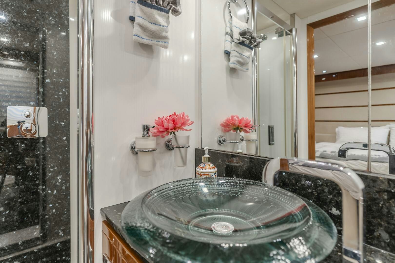 a bathroom with a sink and a mirror aboard INDECENT PROPOSAL IV Yacht for Sale
