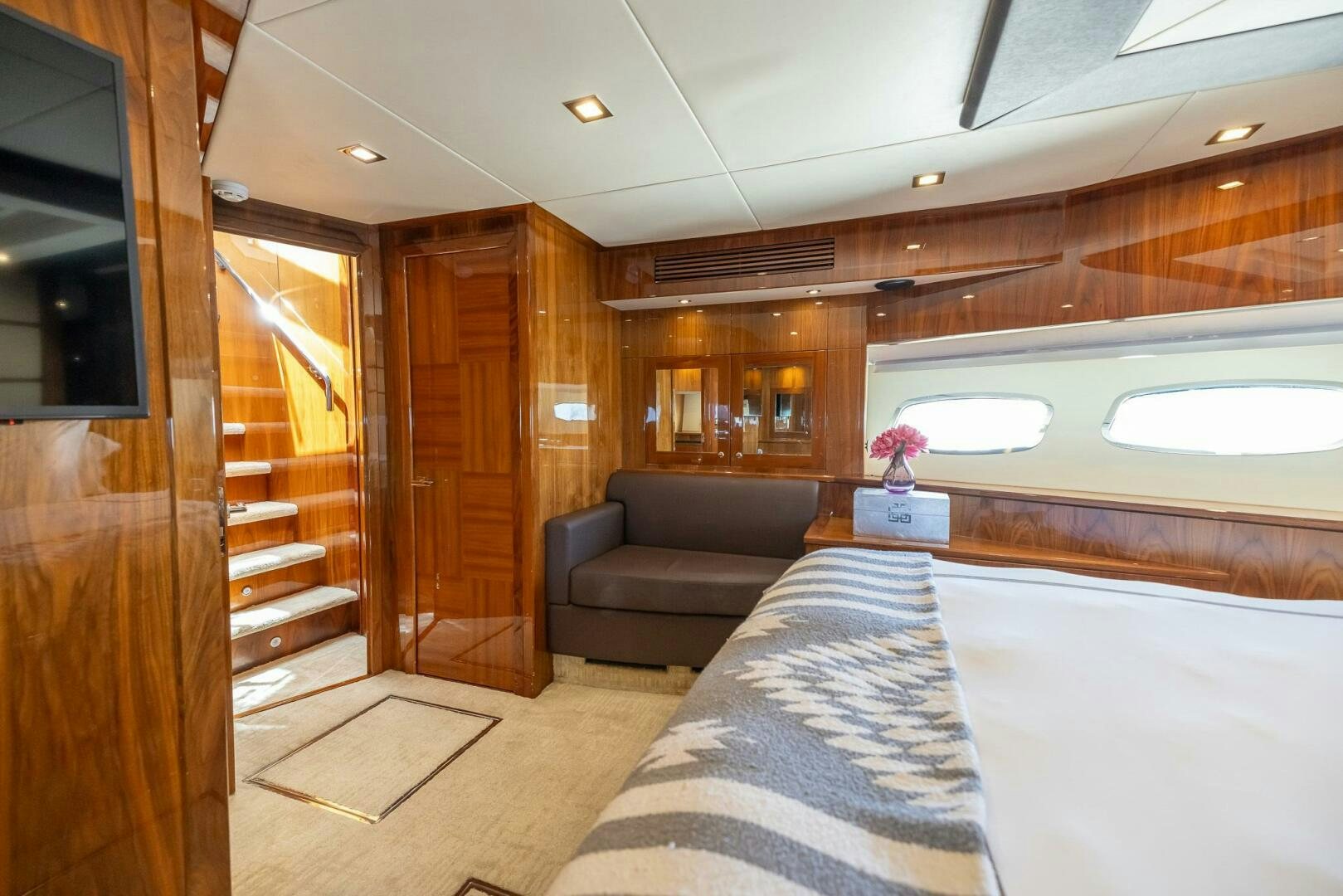 a room with a couch and a tv aboard INDECENT PROPOSAL IV Yacht for Sale