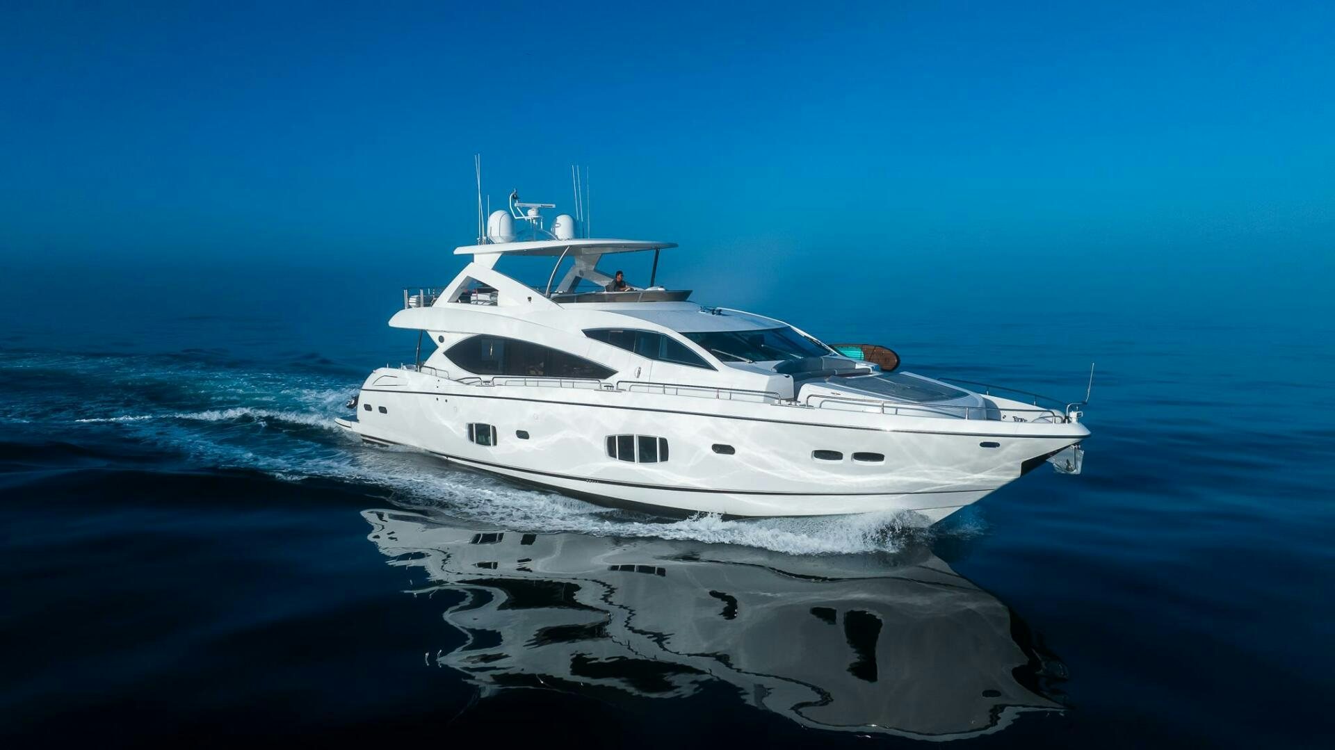 a white yacht on the water aboard INDECENT PROPOSAL IV Yacht for Sale