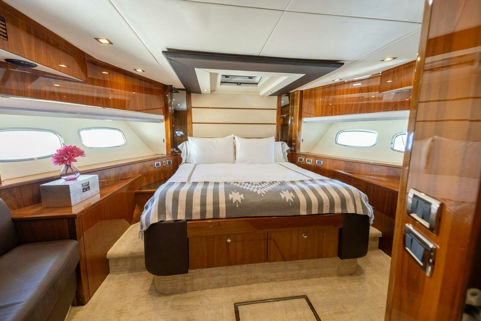 a room with a bed and a table aboard INDECENT PROPOSAL IV Yacht for Sale