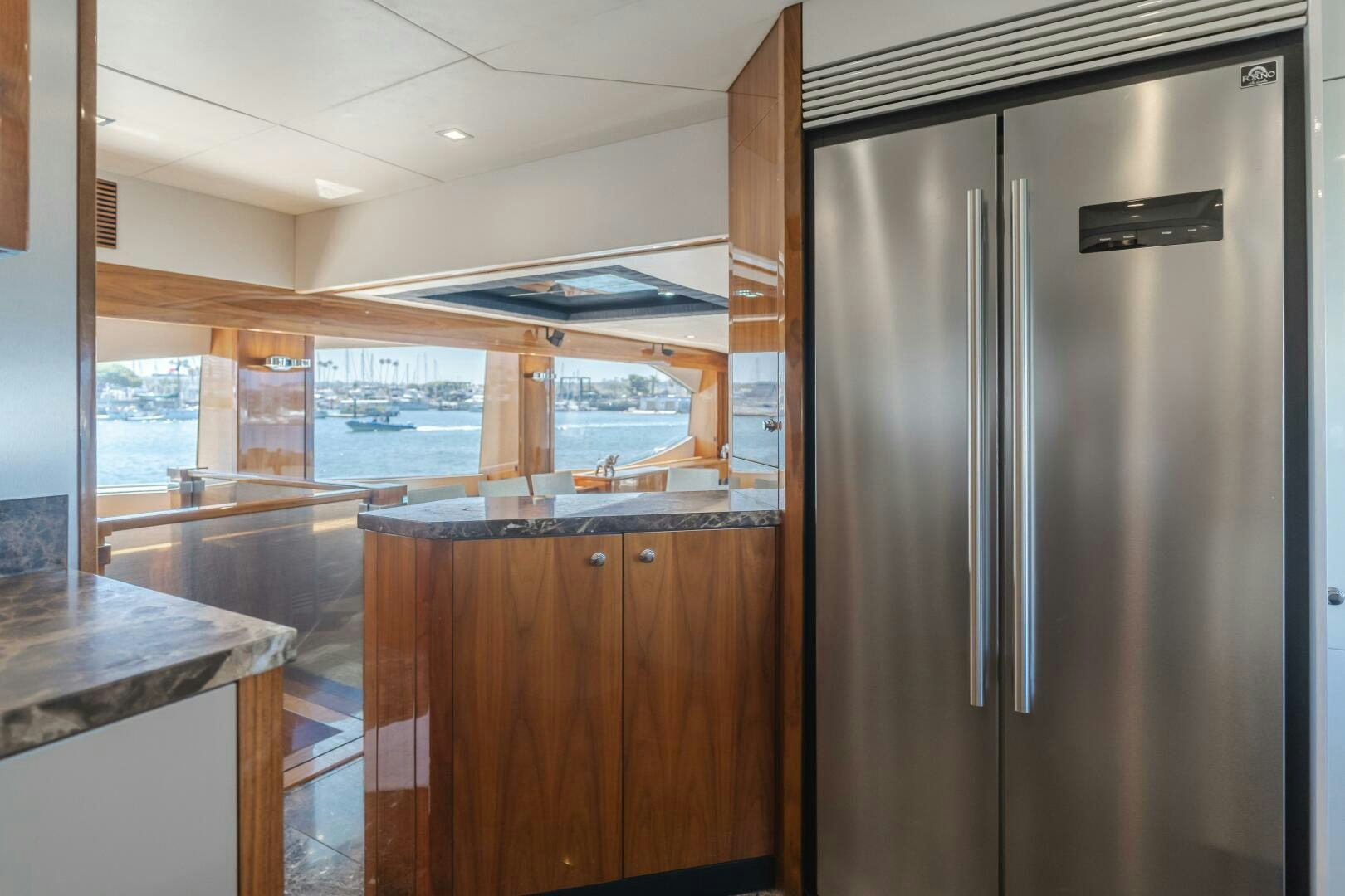 a kitchen with a refrigerator aboard INDECENT PROPOSAL IV Yacht for Sale