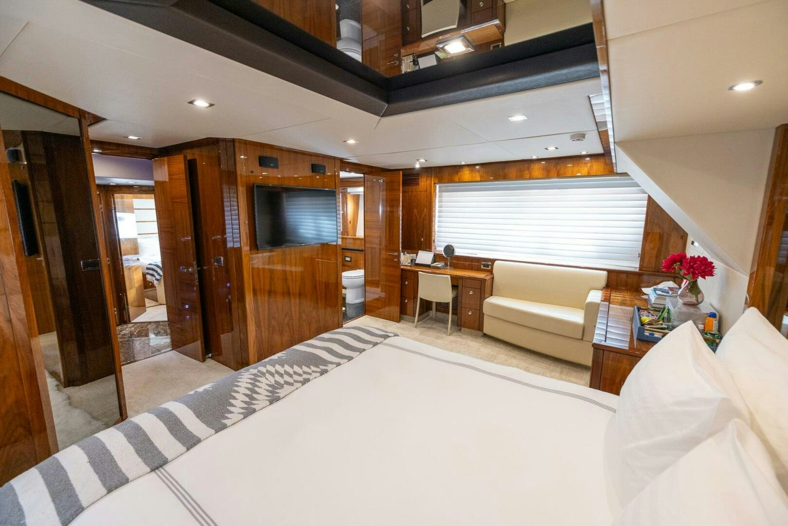 a room with a bed and a television aboard INDECENT PROPOSAL IV Yacht for Sale