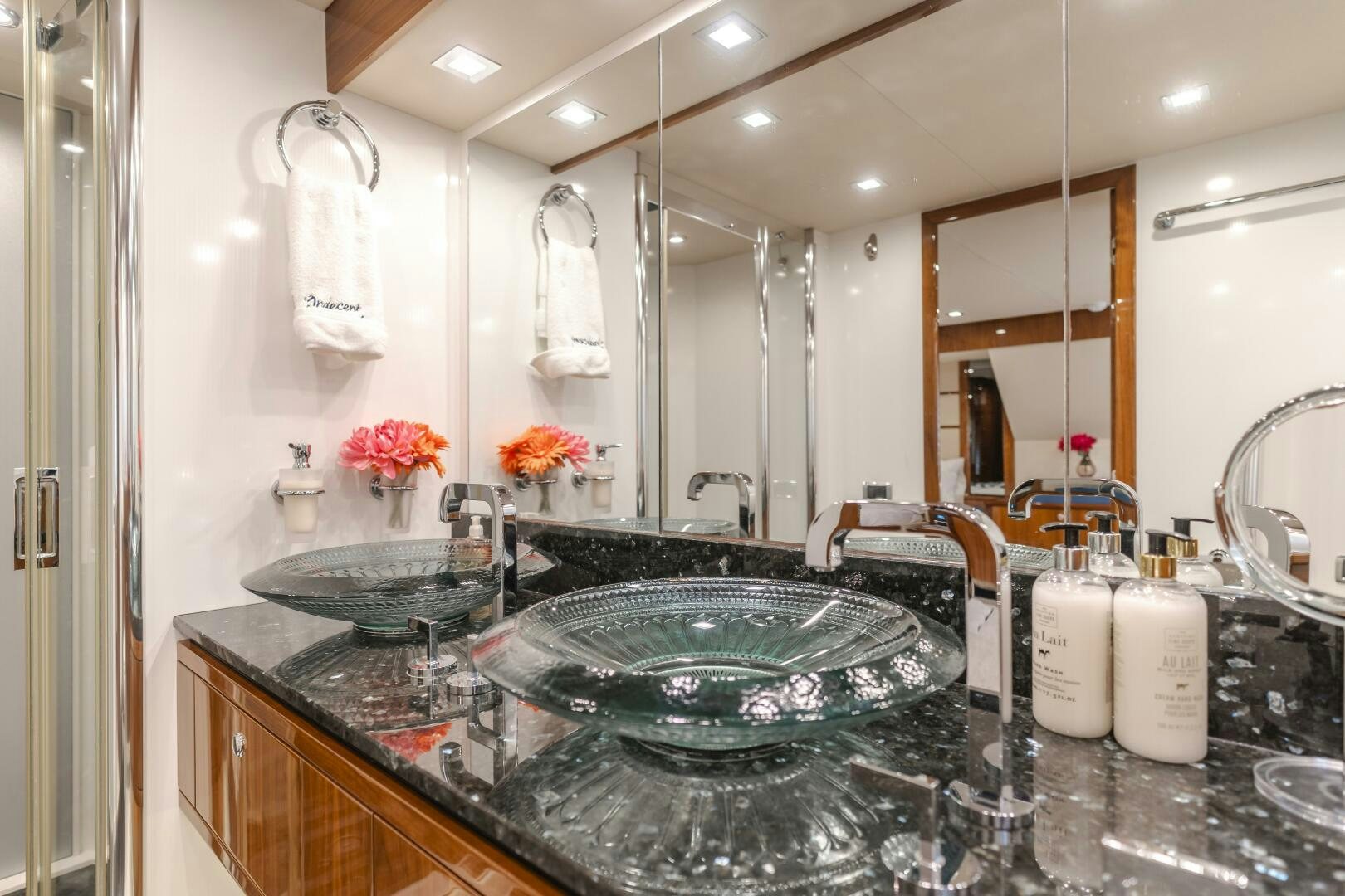 a bathroom with a large mirror aboard INDECENT PROPOSAL IV Yacht for Sale