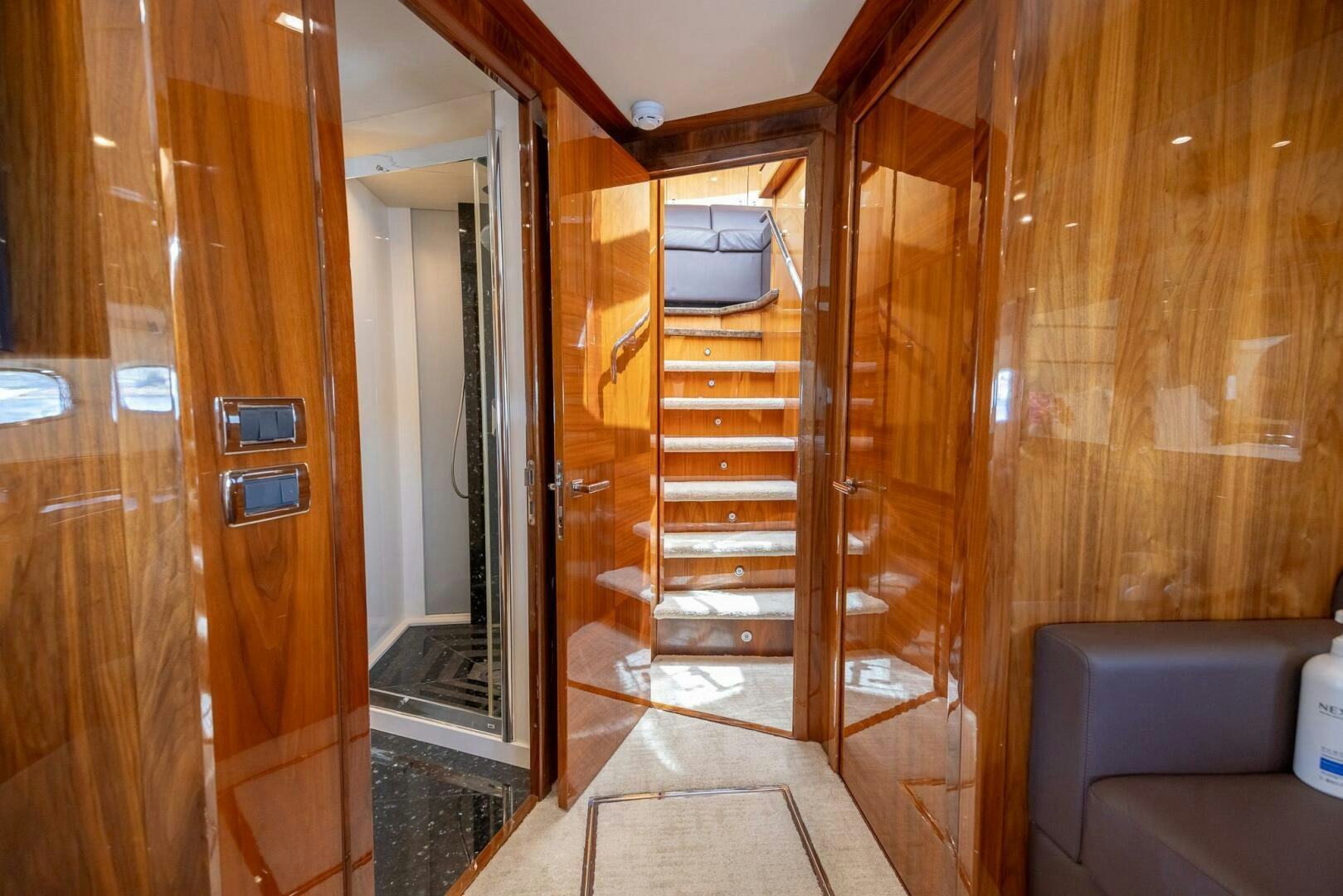 a room with wooden walls and a wood door aboard INDECENT PROPOSAL IV Yacht for Sale