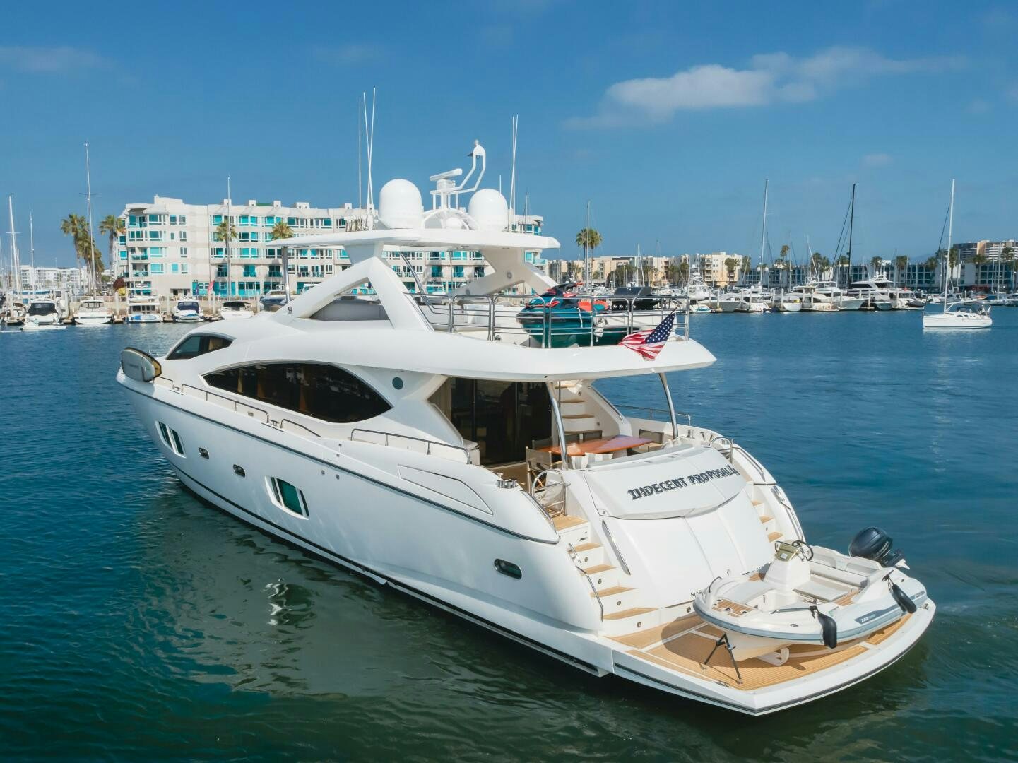 a white yacht in the water aboard INDECENT PROPOSAL IV Yacht for Sale