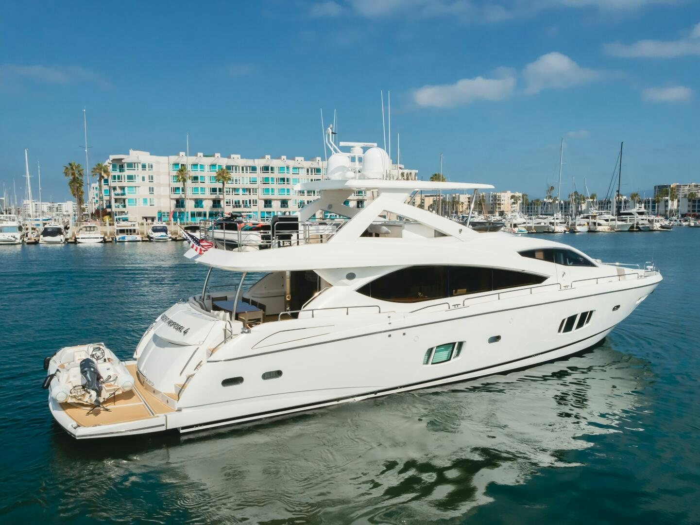 a white yacht in the water aboard INDECENT PROPOSAL IV Yacht for Sale