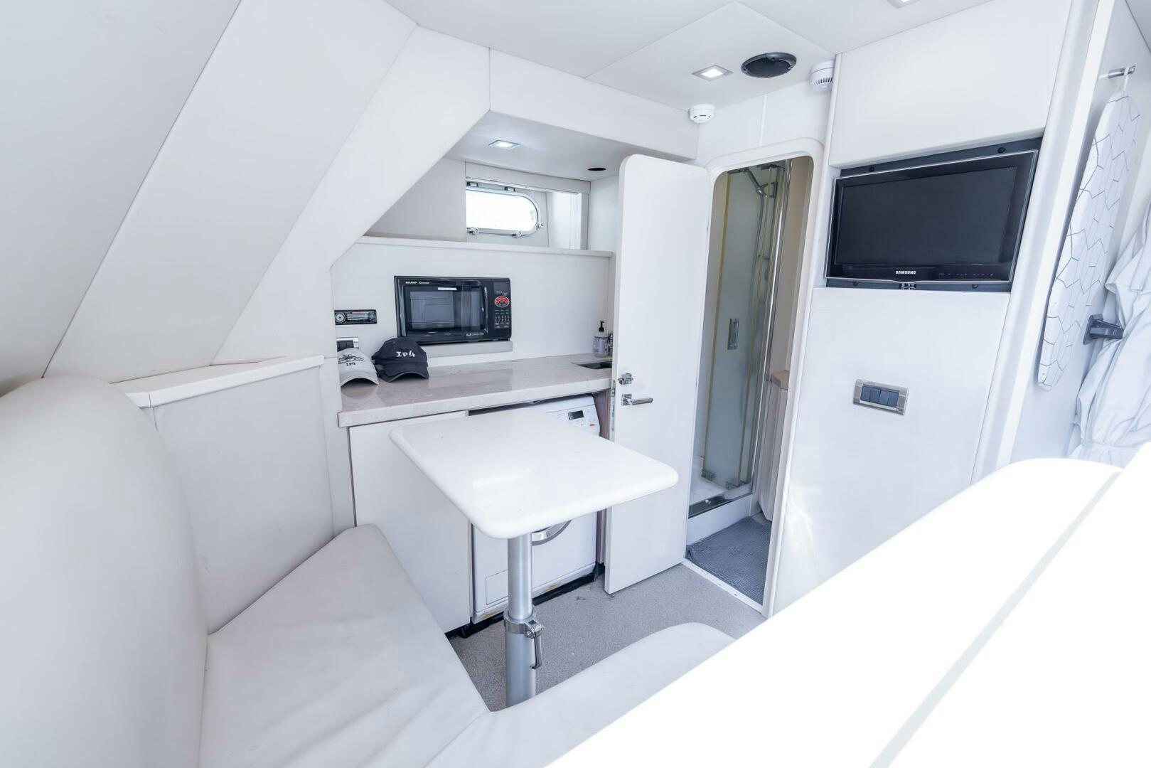 a room with a desk and a tv aboard INDECENT PROPOSAL IV Yacht for Sale