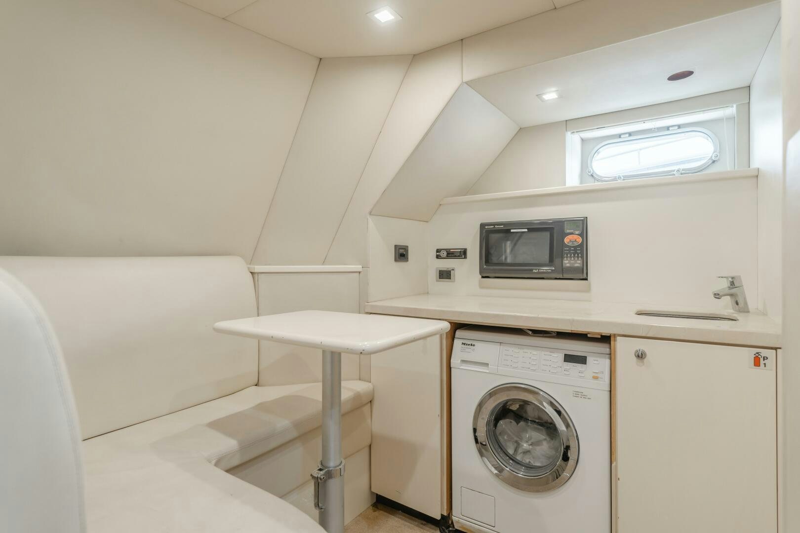a small white kitchen aboard INDECENT PROPOSAL IV Yacht for Sale