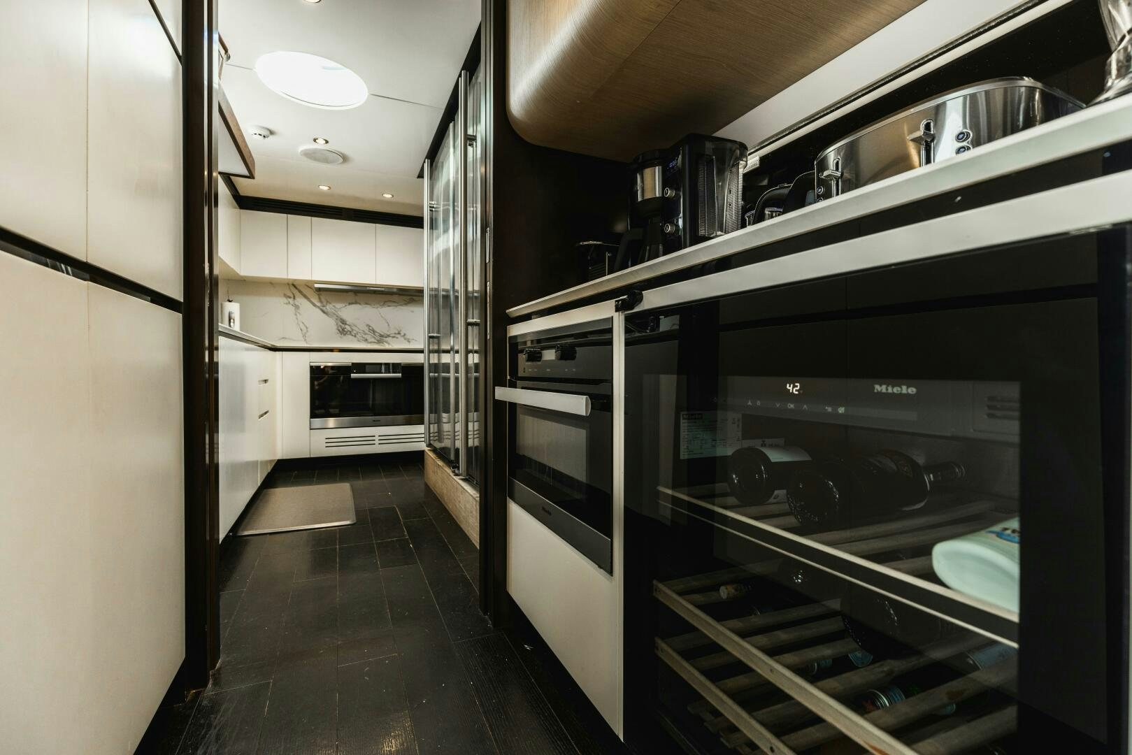 a kitchen with stainless steel appliances aboard MAJESTIC MOMENTS Yacht for Sale